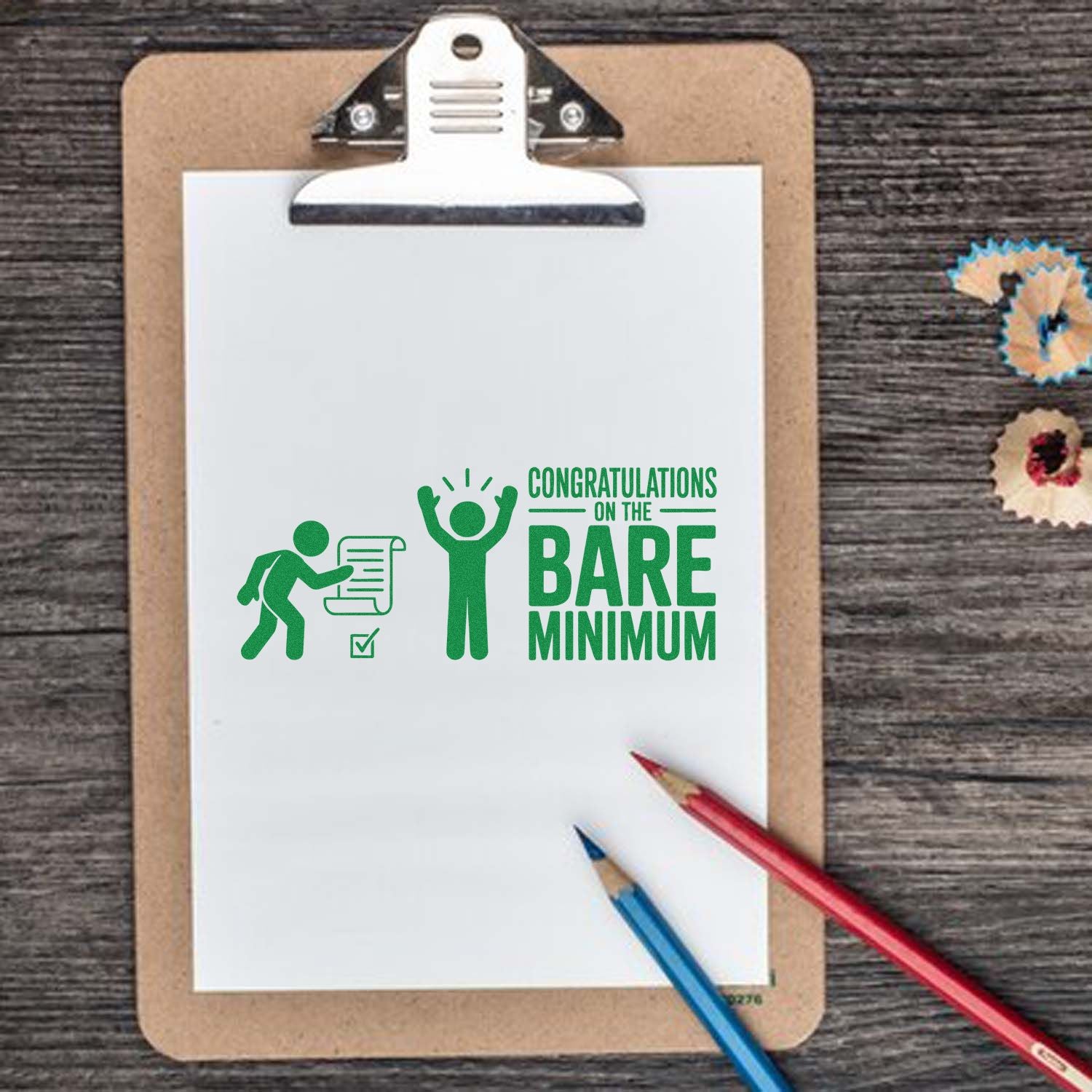 Funny rubber stamp design reading Congratulations on the Bare Minimum on clipboard with pencils, ideal for office humor and greeting cards