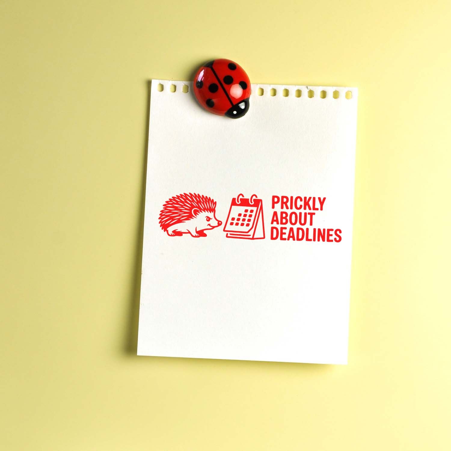 Custom rubber stamp impression reading Prickly About Deadlines with hedgehog and calendar on notepad, office humor.