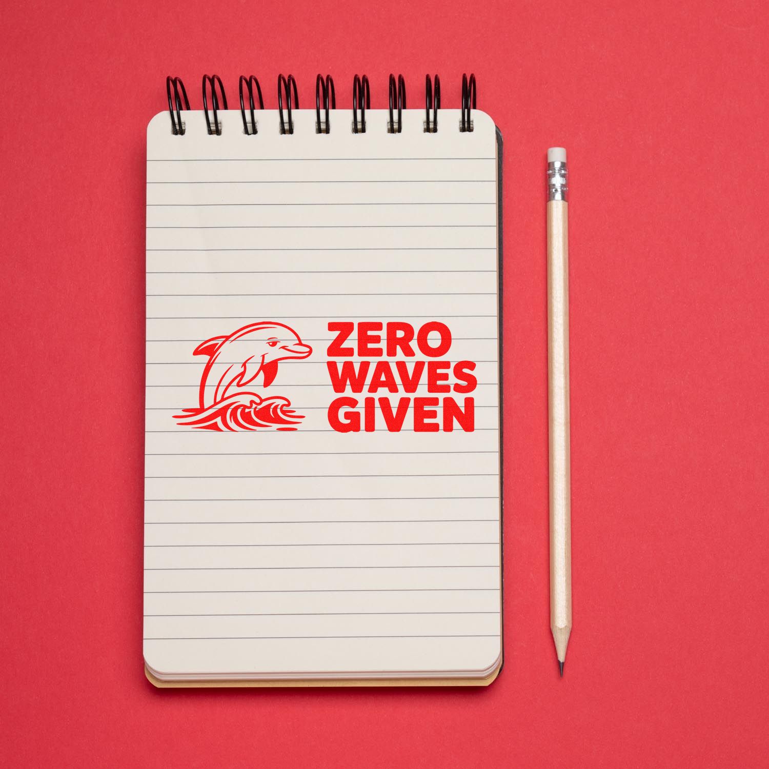 Zero Waves Given dolphin rubber stamp design on notebook, perfect for coastal crafts, marine gifts and stationery
