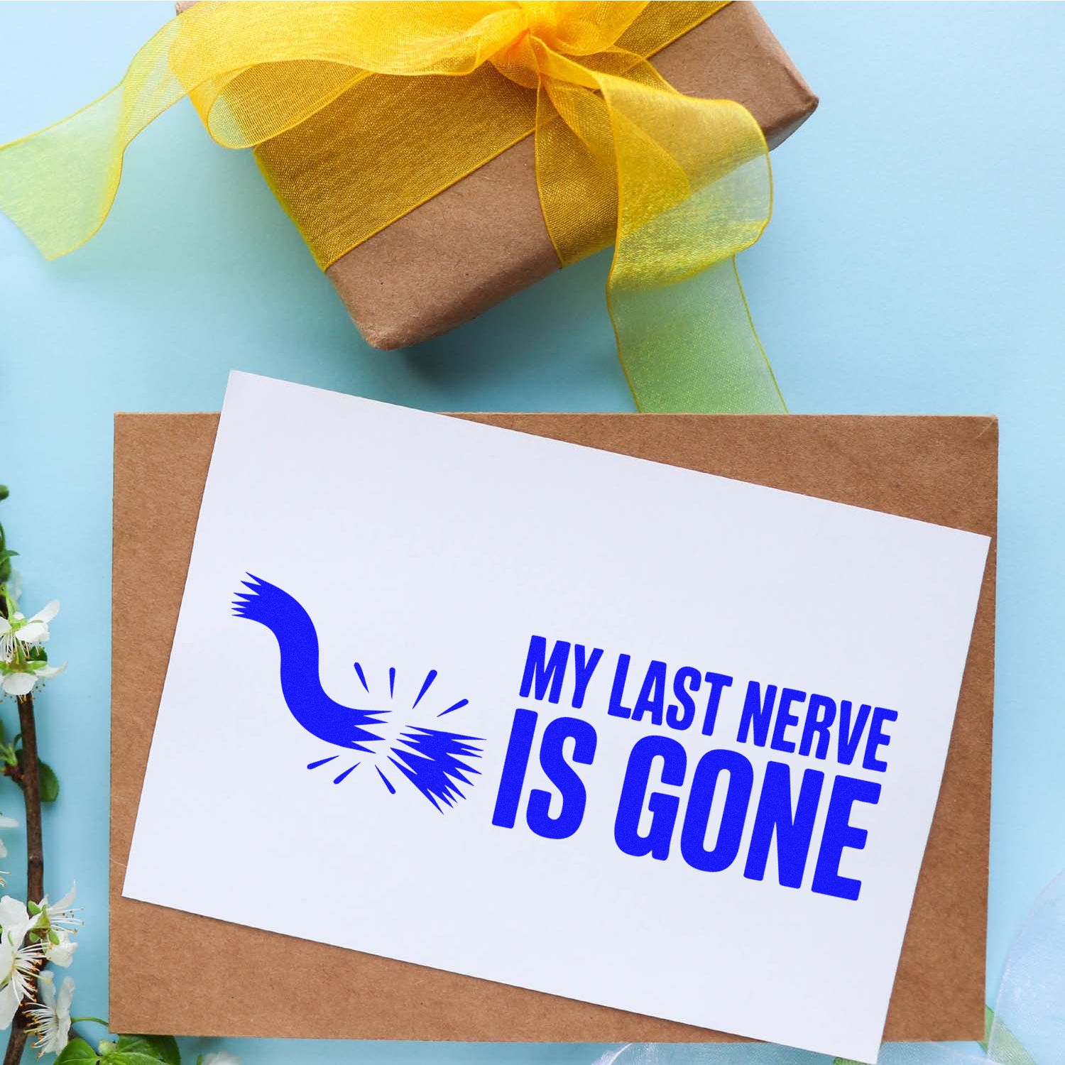 Funny rubber stamp reading My Last Nerve Is Gone on a greeting card, ideal for sarcastic notes and gift packaging.