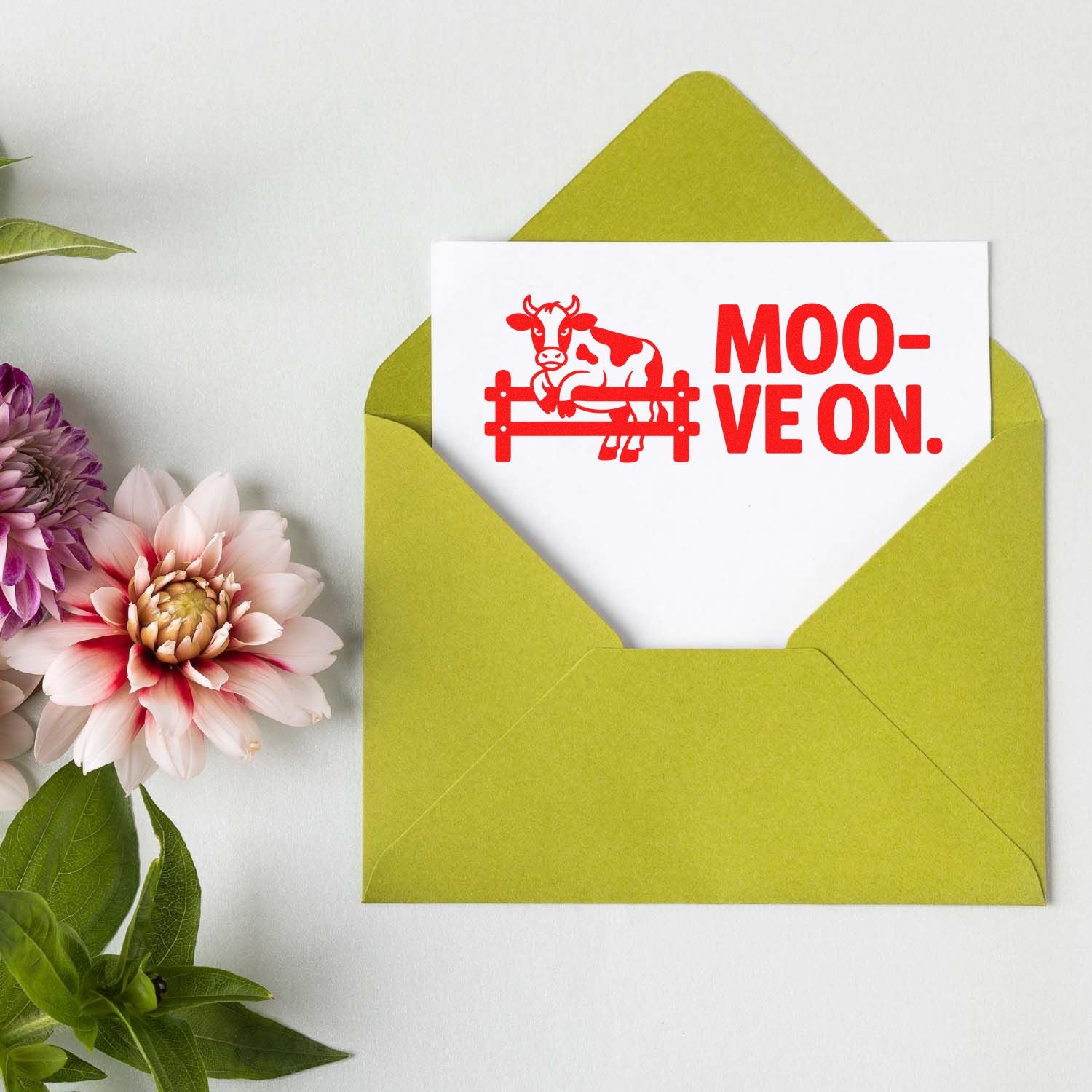 Cow rubber stamp greeting card in green envelope with Moo-ve On pun for farm-themed mail and cards.