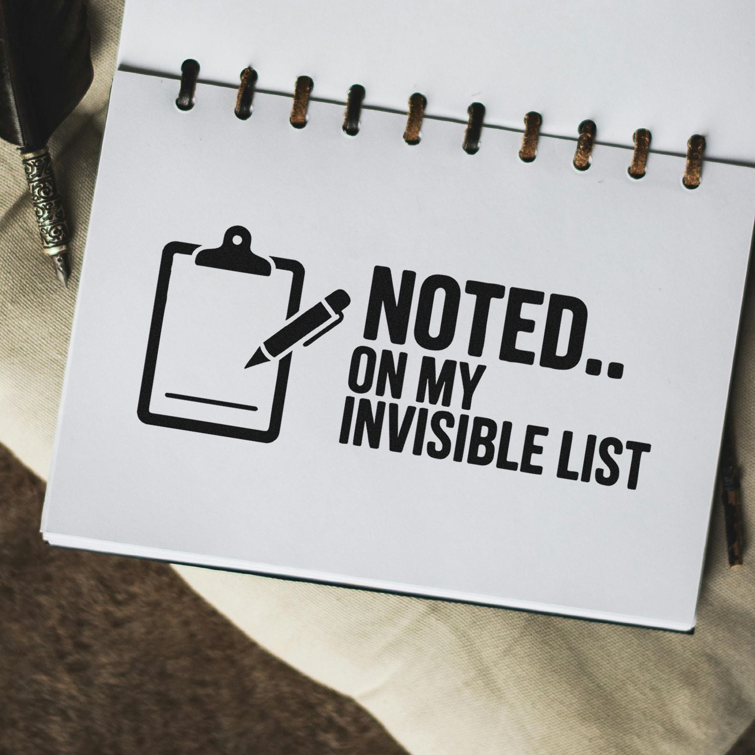 Funny rubber stamp-style notebook graphic reading Noted on My Invisible List with clipboard and pen icon.