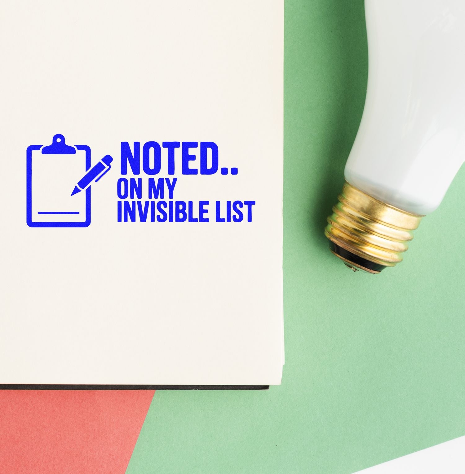 Custom rubber stamp design reading Noted on my invisible list with clipboard icon on a notebook page.