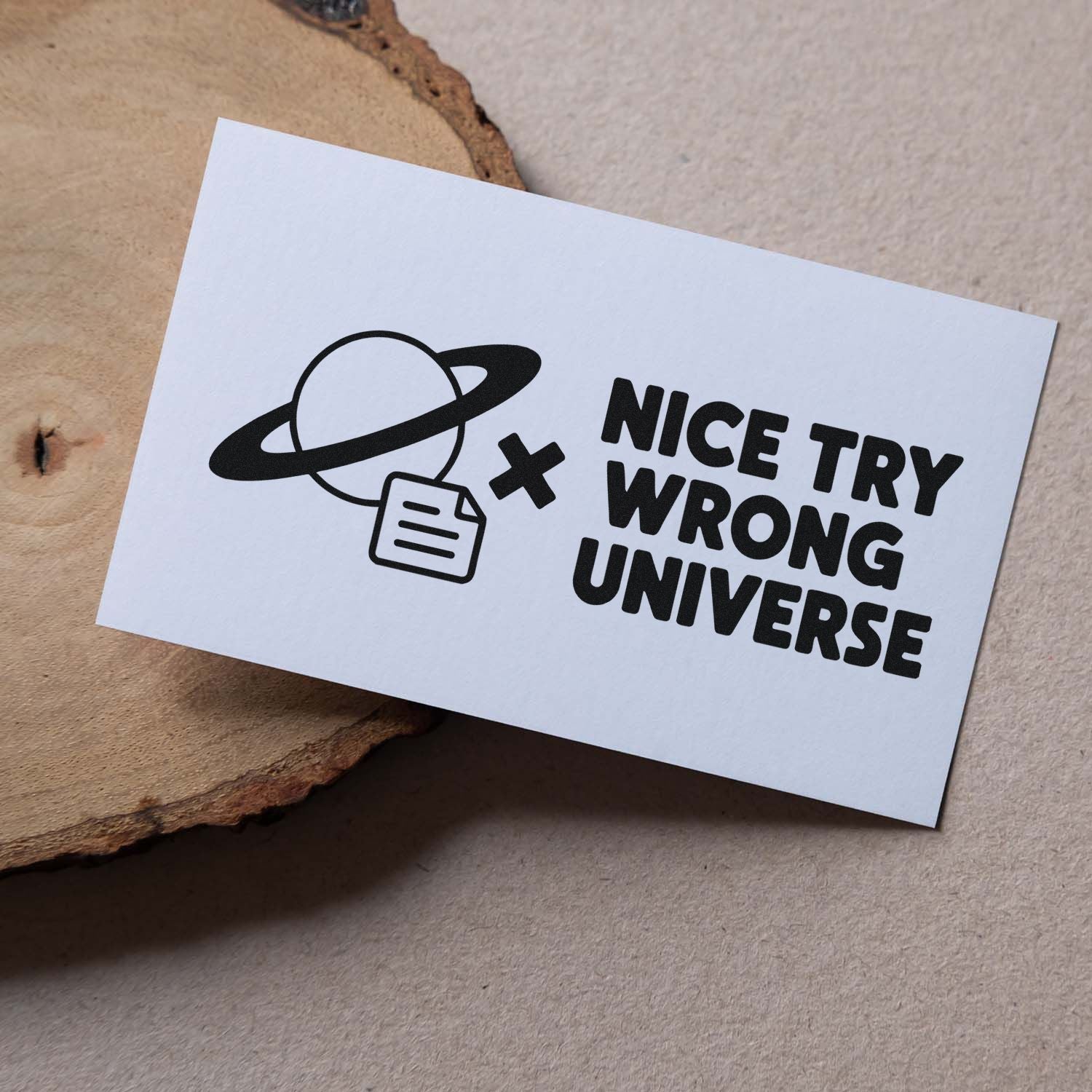 Custom rubber stamp design with planet icon and Nice Try Wrong Universe quote on white card