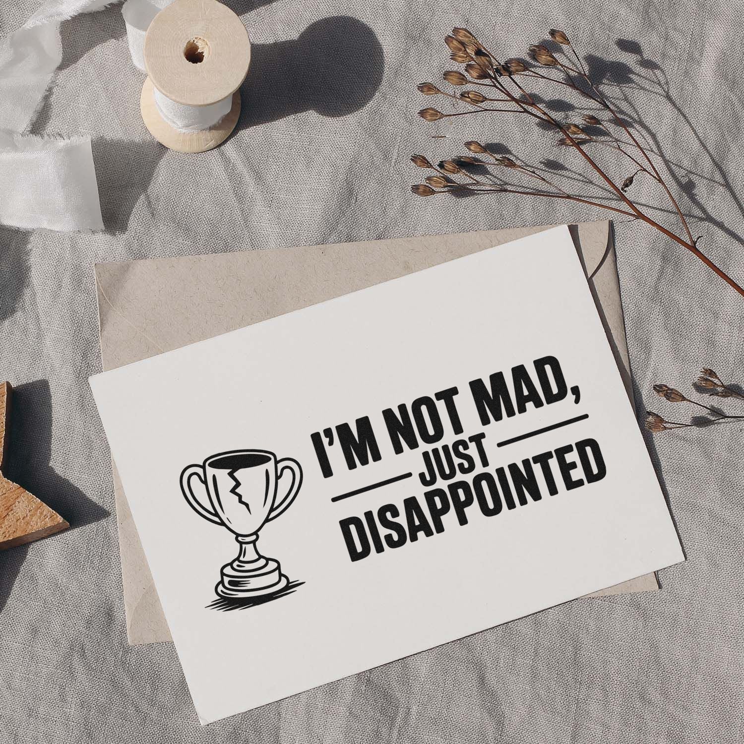 Humorous rubber stamp design with trophy icon and Im not mad, just disappointed sentiment for stationery and cards.