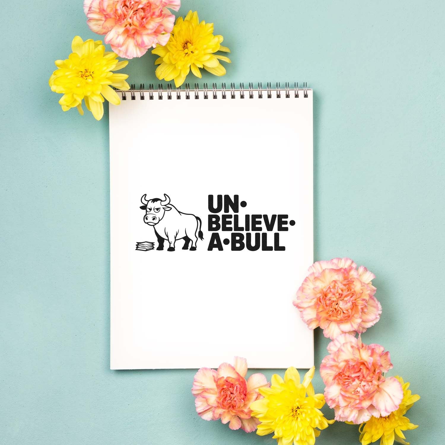 Funny Un-Believe-A-Bull bull rubber stamp on notebook, ideal for cards, planners, and craft projects.