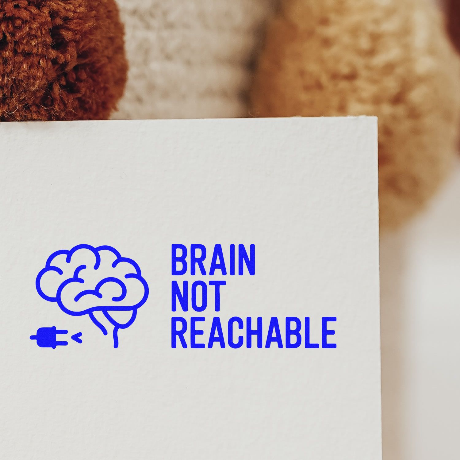 Blue Brain Not Reachable rubber stamp design with brain icon and unplugged plug on white paper.