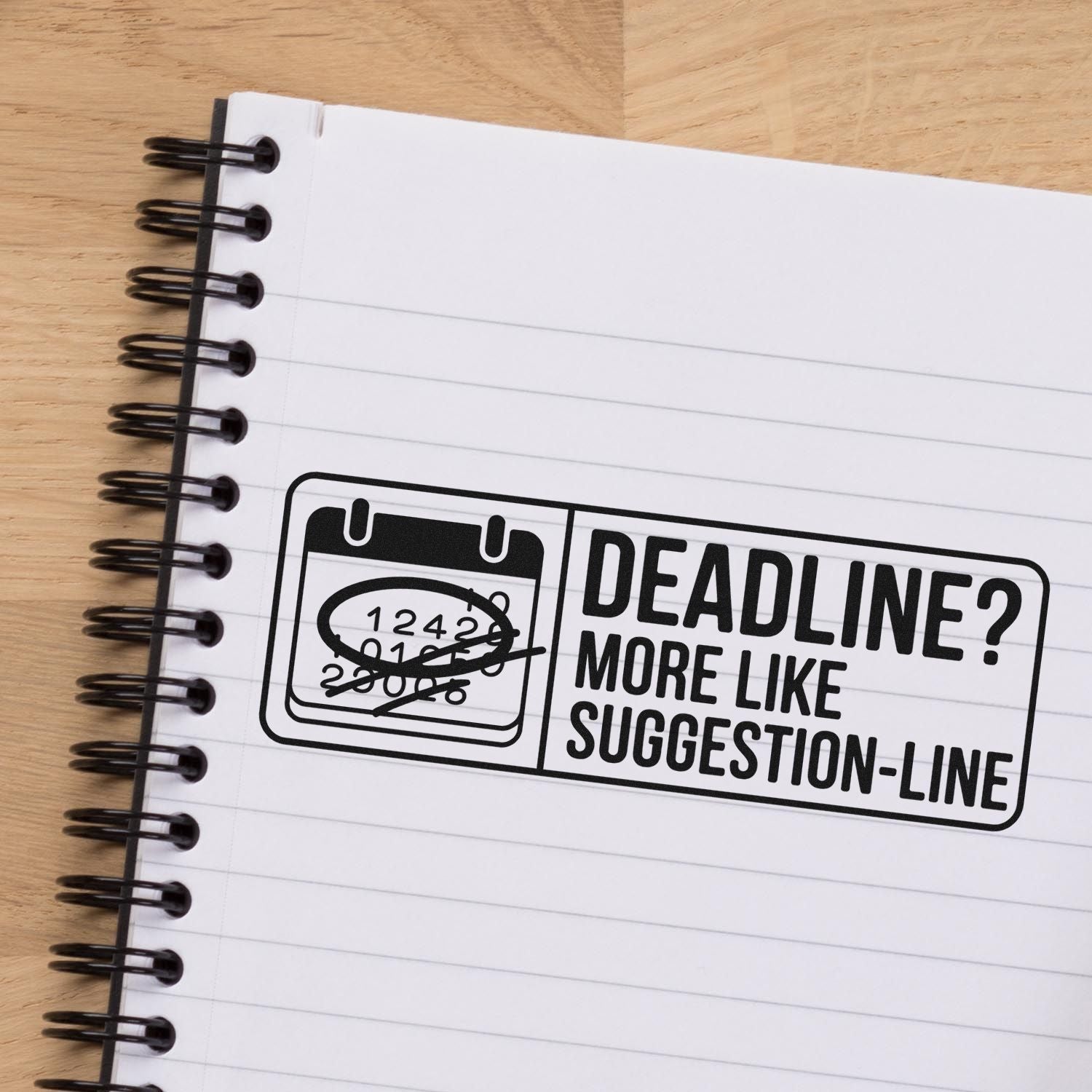 Custom rubber stamp reading Deadline? More like suggestion-line on notebook, with crossed-out calendar for office humor.