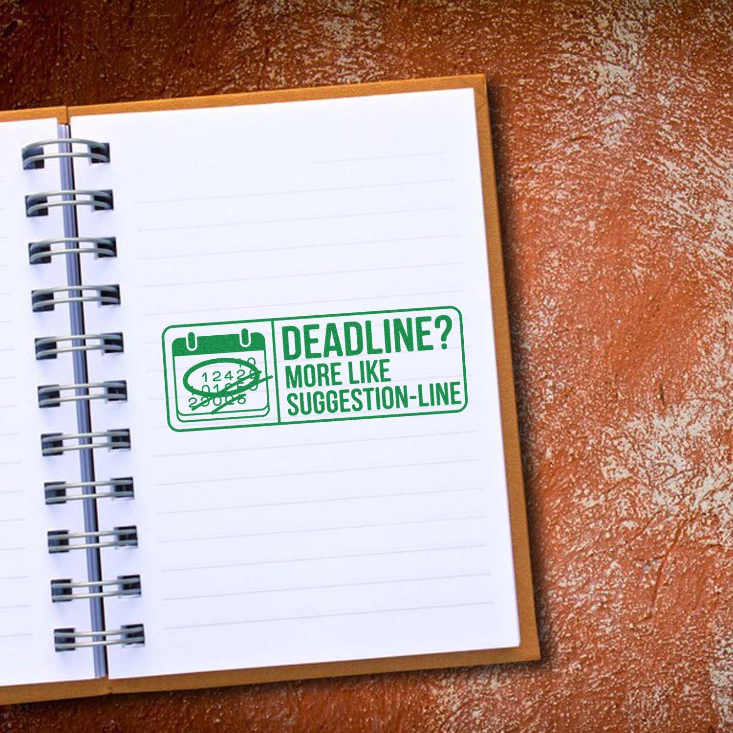 Humorous rubber stamp on planner page reading Deadline? More Like Suggestion-Line for office and productivity use.