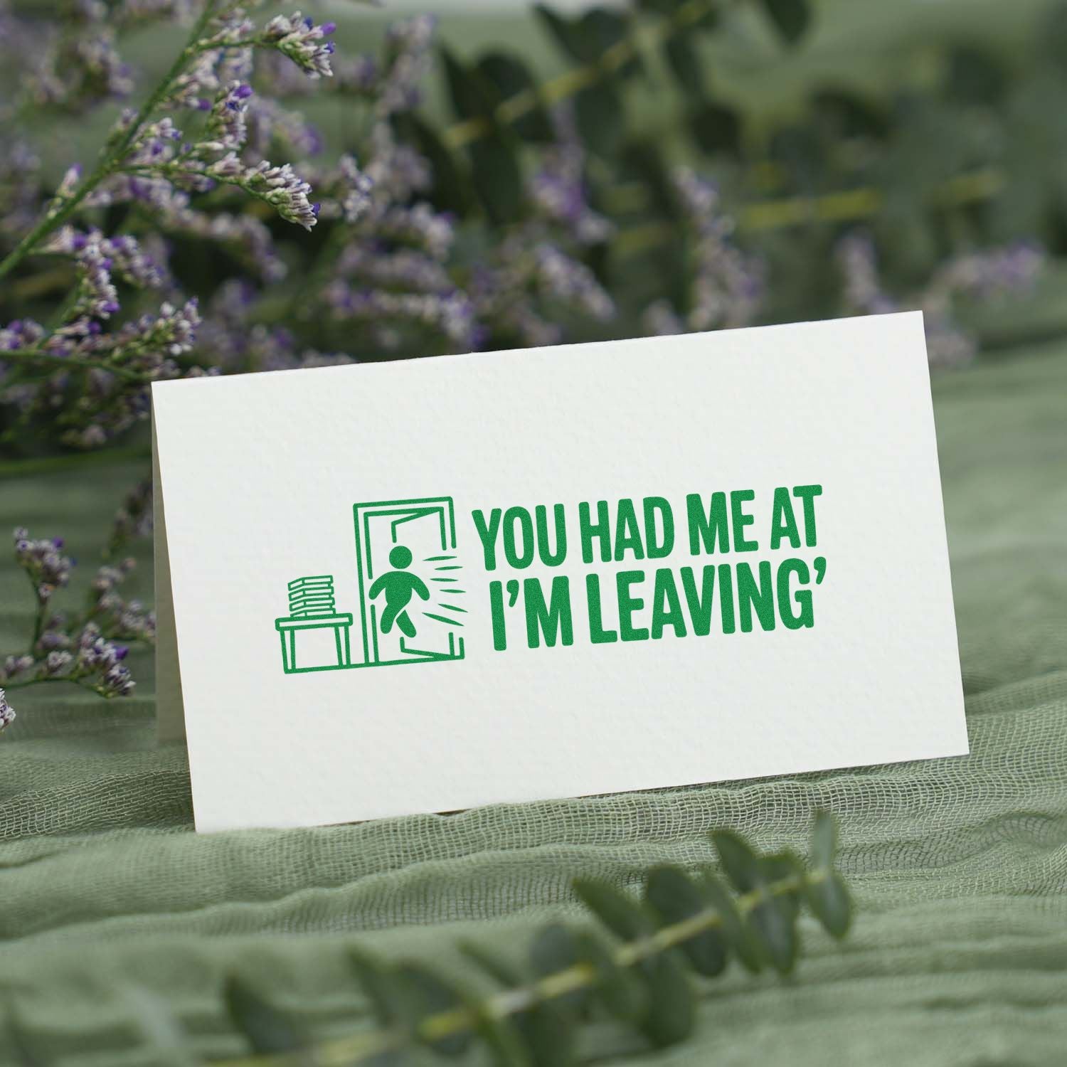 Custom rubber stamp design reading You had me at Im leaving on a greeting card, with a playful exit icon.