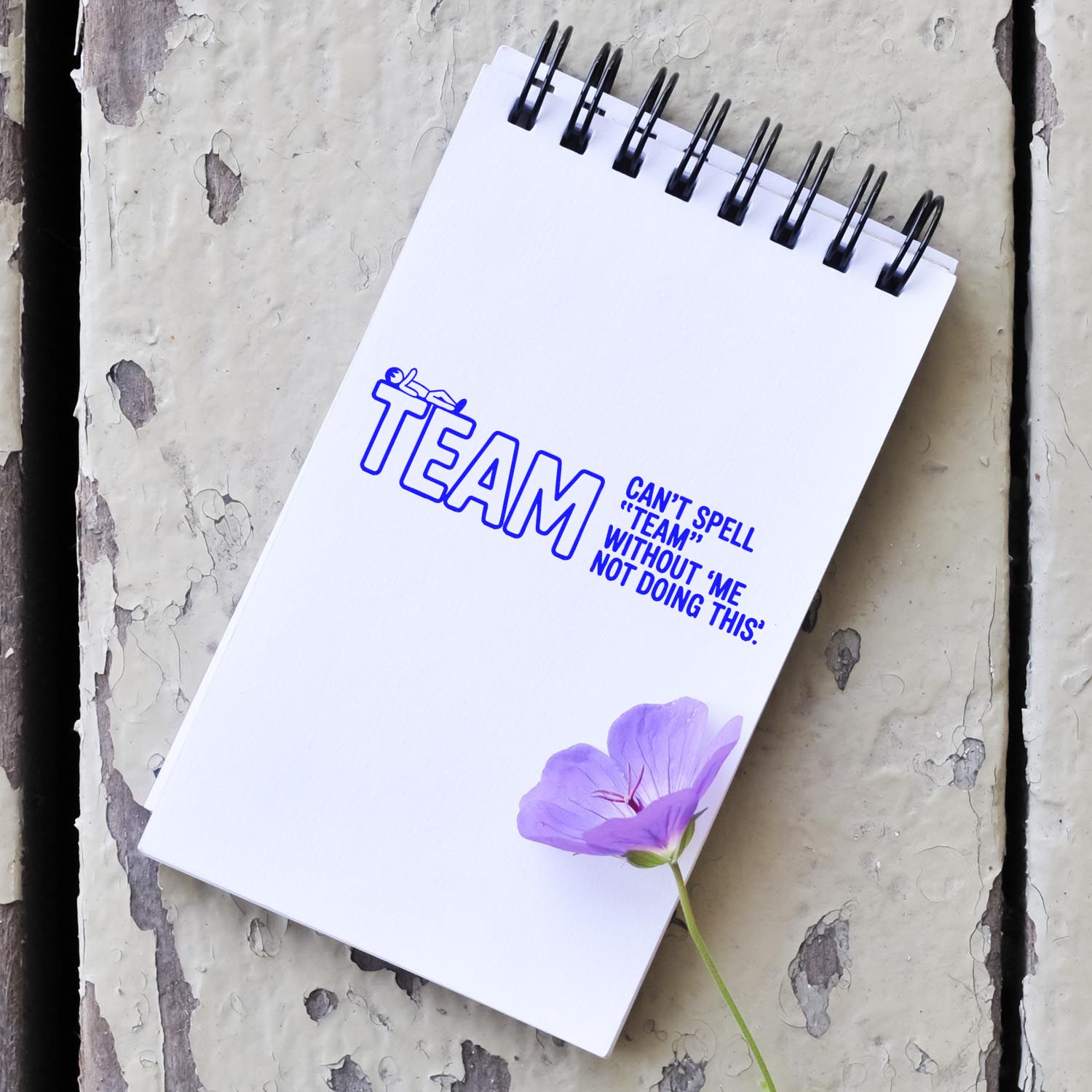 Custom rubber stamp impression on notebook with TEAM: Cant spell team without me quote, ideal for office humor and craft projects.