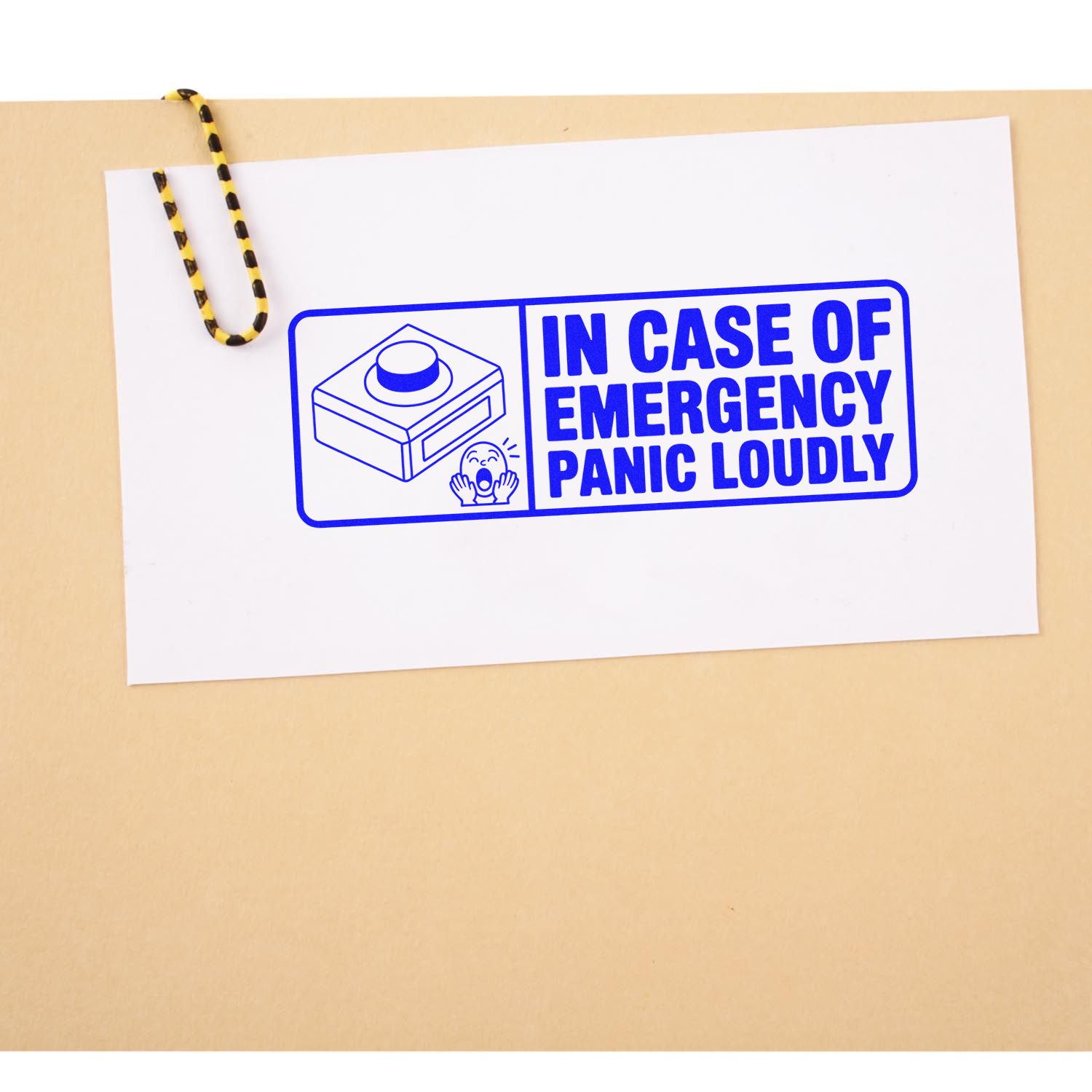 Blue rubber stamp reading In Case of Emergency, Panic Loudly with emergency button icon on paper.