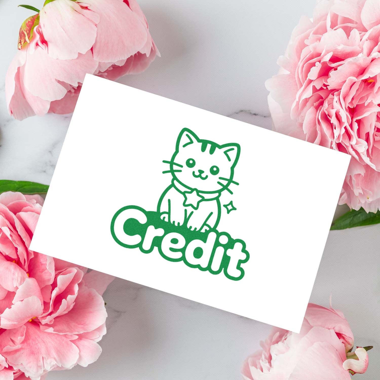 Cute cat 'Credit' rubber stamp design for planners, journals, and handmade craft labels, shown on a floral mockup.