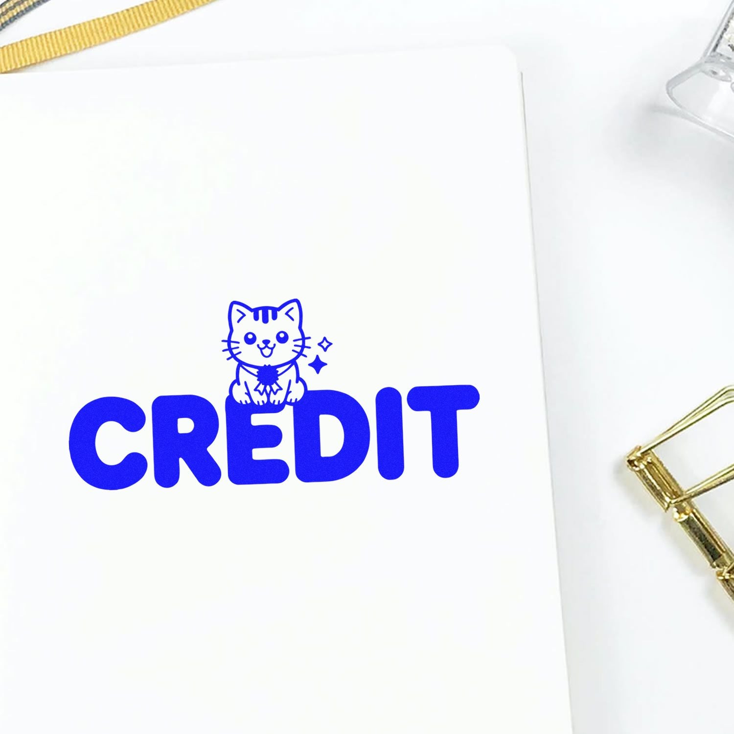 Blue CREDIT stamp design with a cute cat illustration, stamped on white paper for business or craft use.