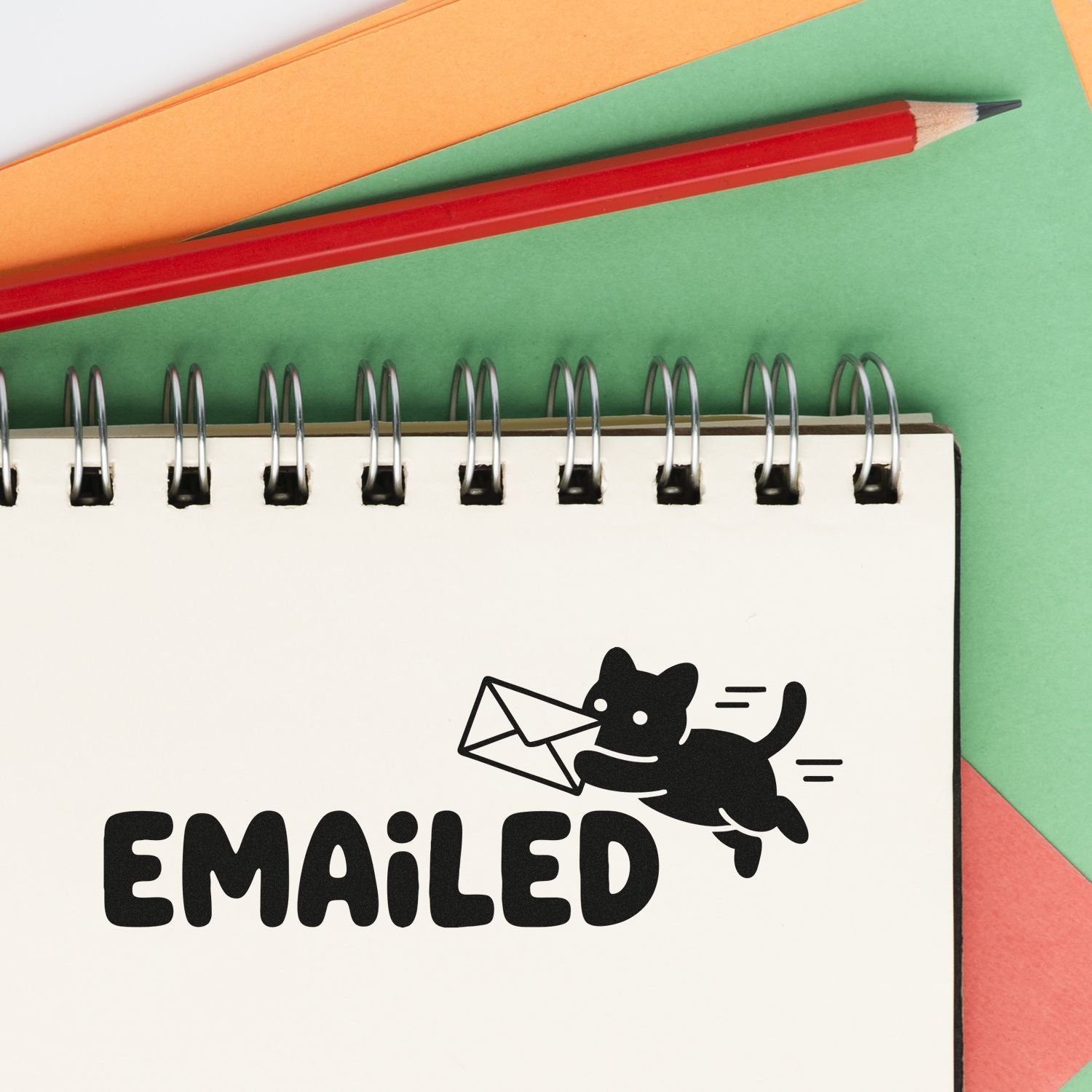 Emailed rubber stamp graphic on notebook with cat and envelope, ideal for office mail tracking and productivity organization.