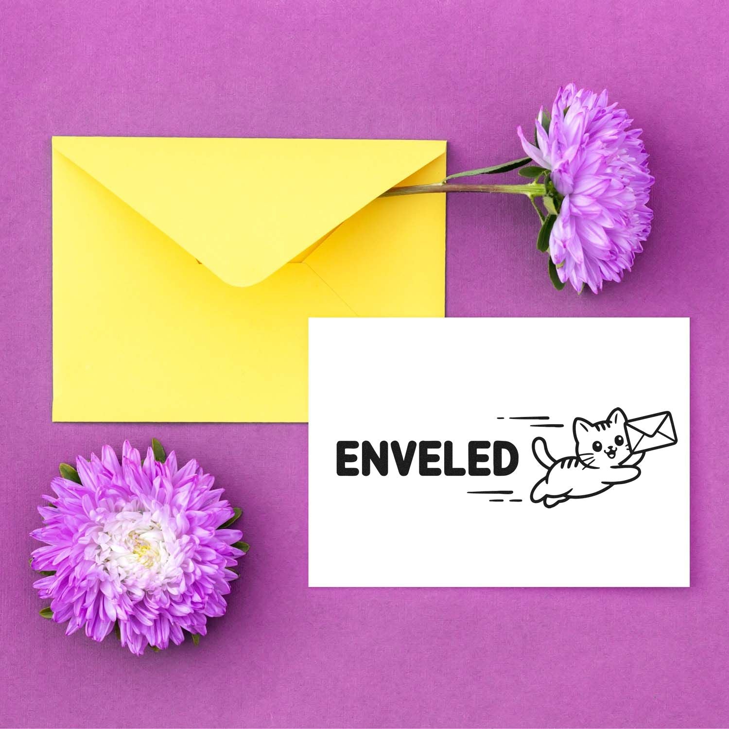 Enveled cat mail rubber stamp design with flying cat carrying an envelope, styled on stationery with flowers.