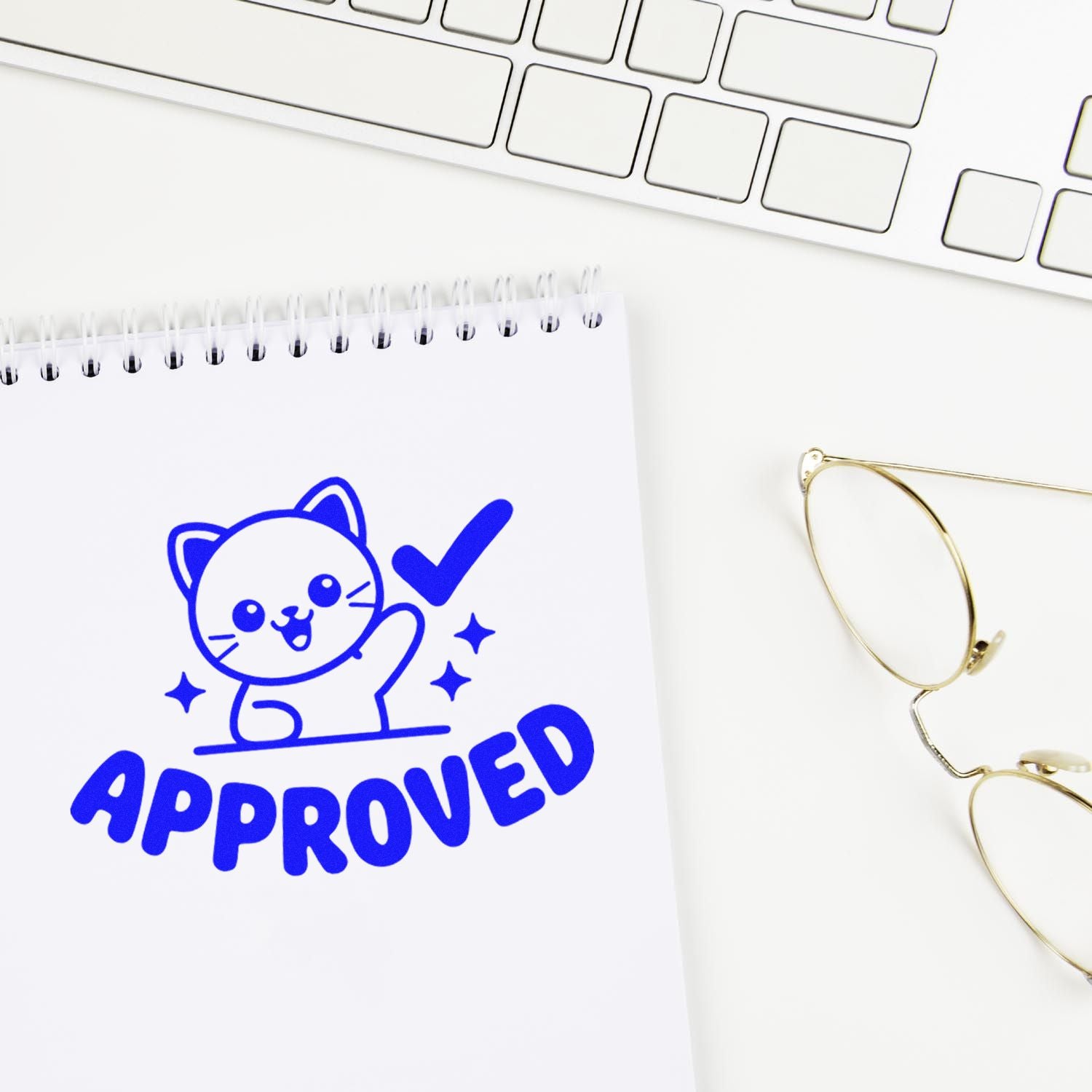 Blue custom rubber stamp with cat and approved checkmark on notebook for office or teacher use.