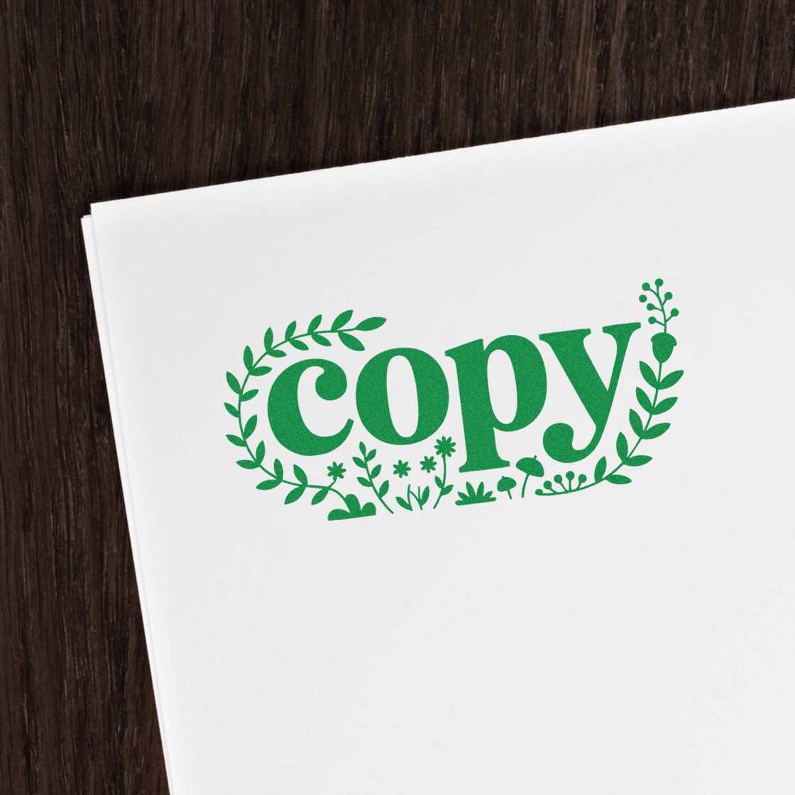 Green floral copy rubber stamp imprint on white paper for office document marking and branding.
