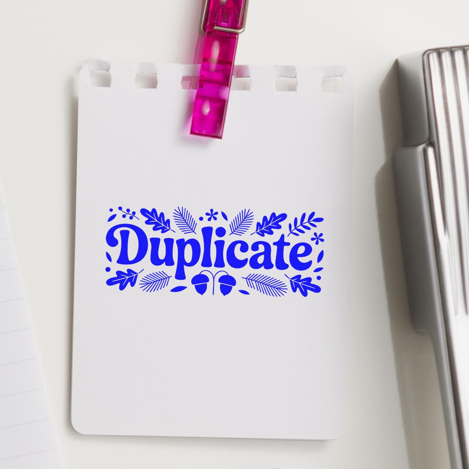 Blue decorative Duplicate rubber stamp impression on white paper for office document marking.