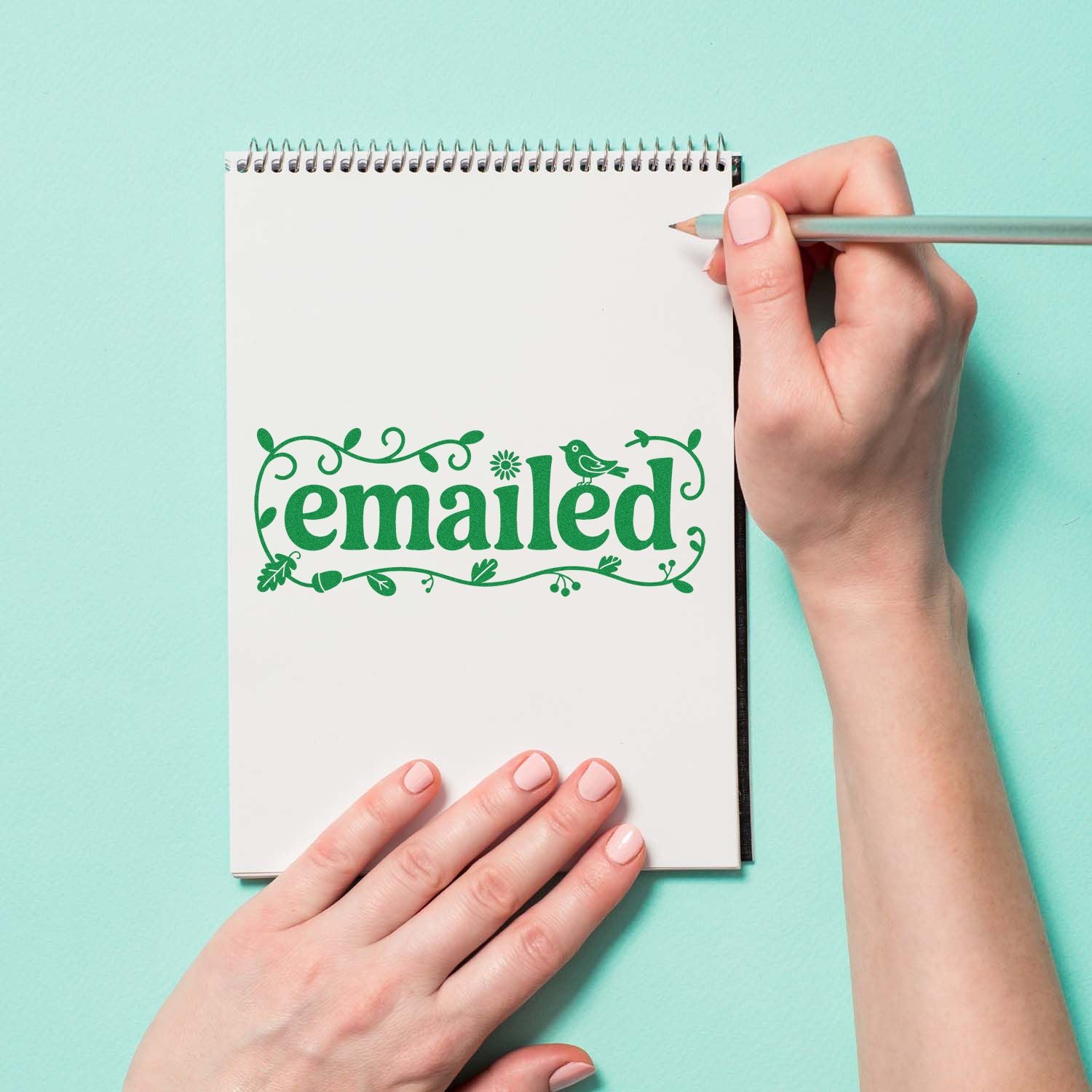 Floral emailed rubber stamp on notebook page, perfect for office workflow and mail tracking.