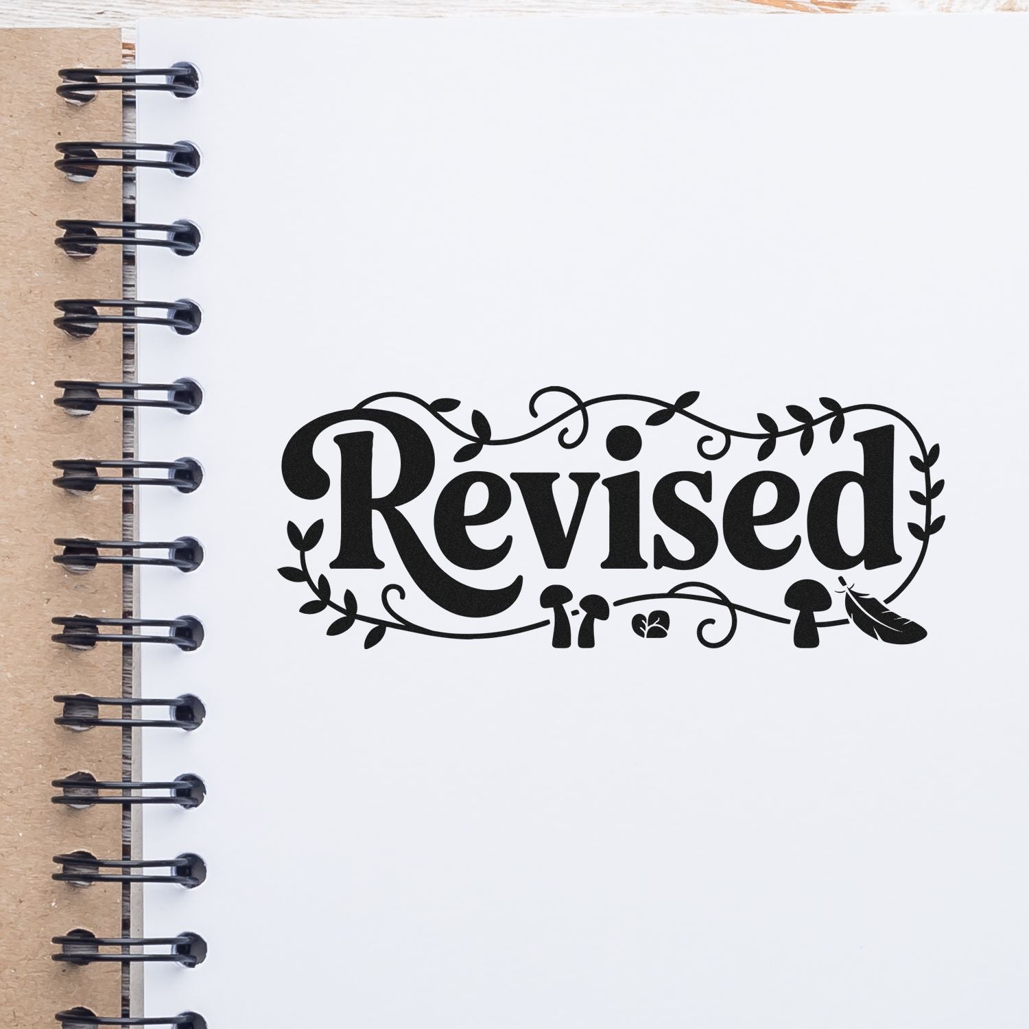 Decorative Revised rubber stamp impression on notebook page, ideal for marking edited documents, reviews, and approvals.