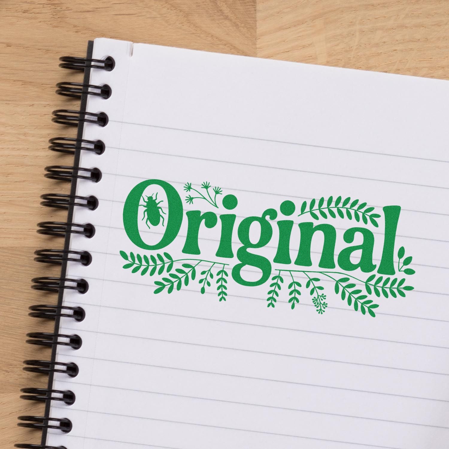 Original custom rubber stamp impression with bug and leaf design on notebook, ideal for eco-friendly packaging and branding