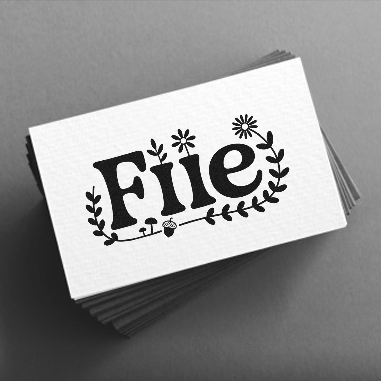 Custom floral rubber stamp design with File text for office filing labels on stacked cards.