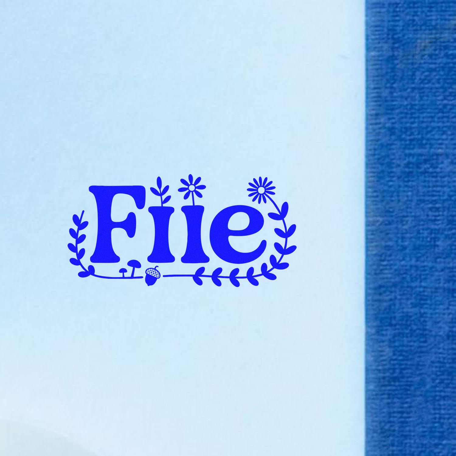 Blue floral File rubber stamp impression on white paper for office document labeling and organization.