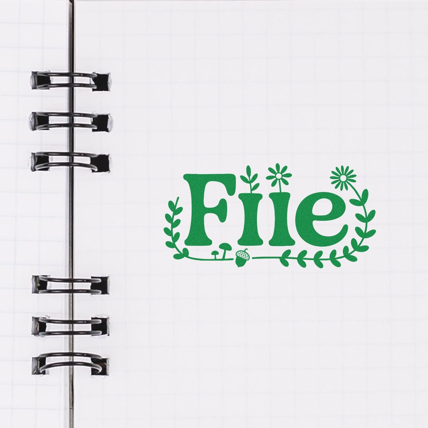 Green floral File custom rubber stamp design on a spiral notebook page.