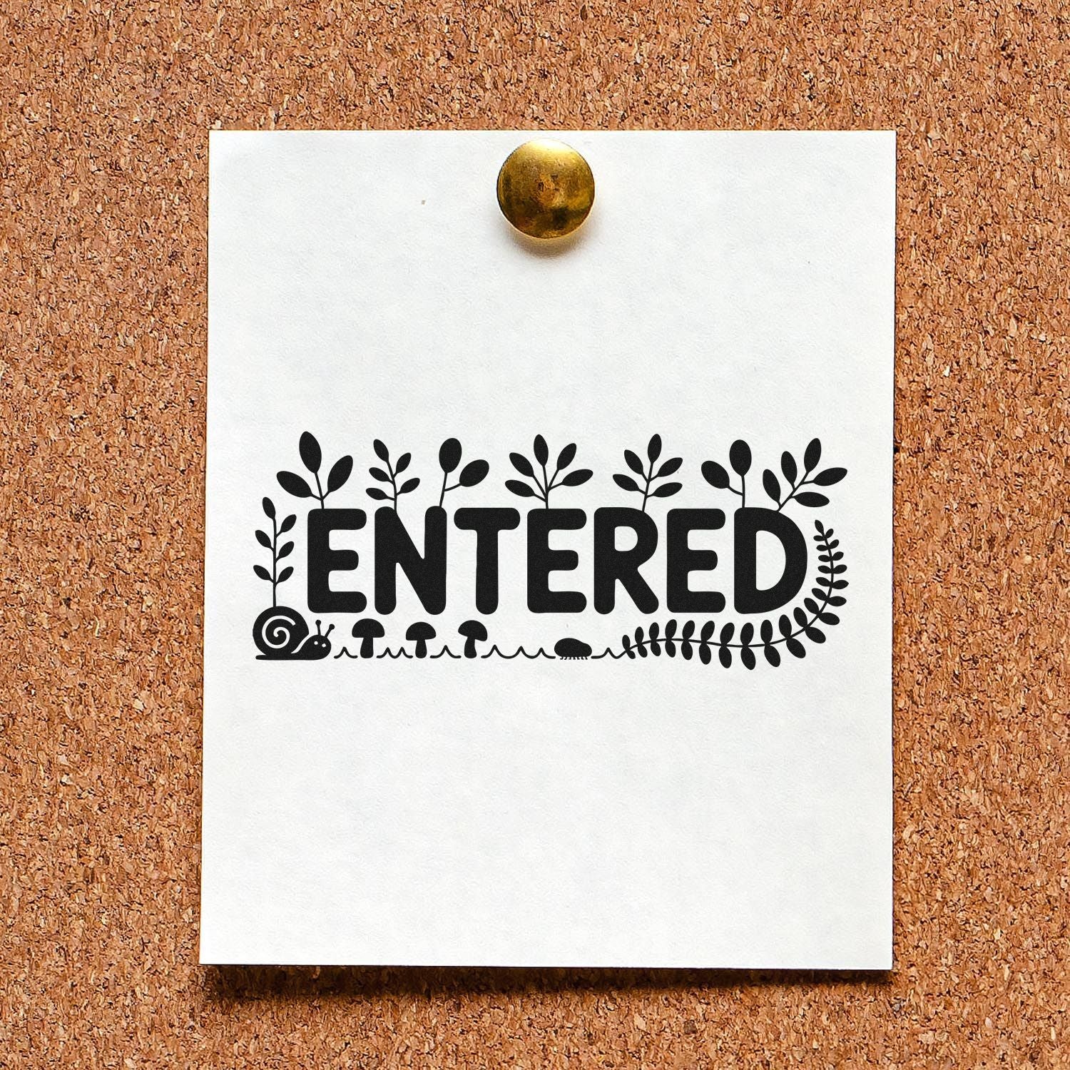 Decorative ENTERED custom rubber stamp with botanical border on pinned paper, ideal for office or craft use.