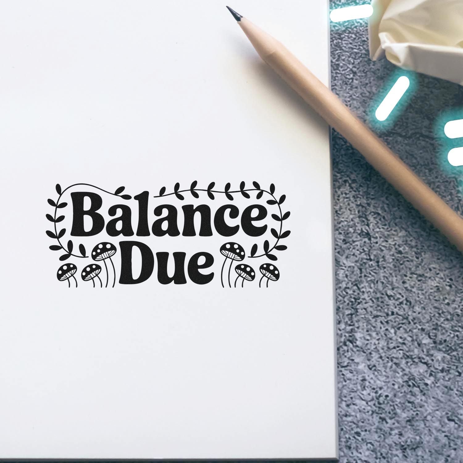 Balance Due rubber stamp design with decorative mushrooms and leaves on a notebook page, ideal for invoices and crafts.
