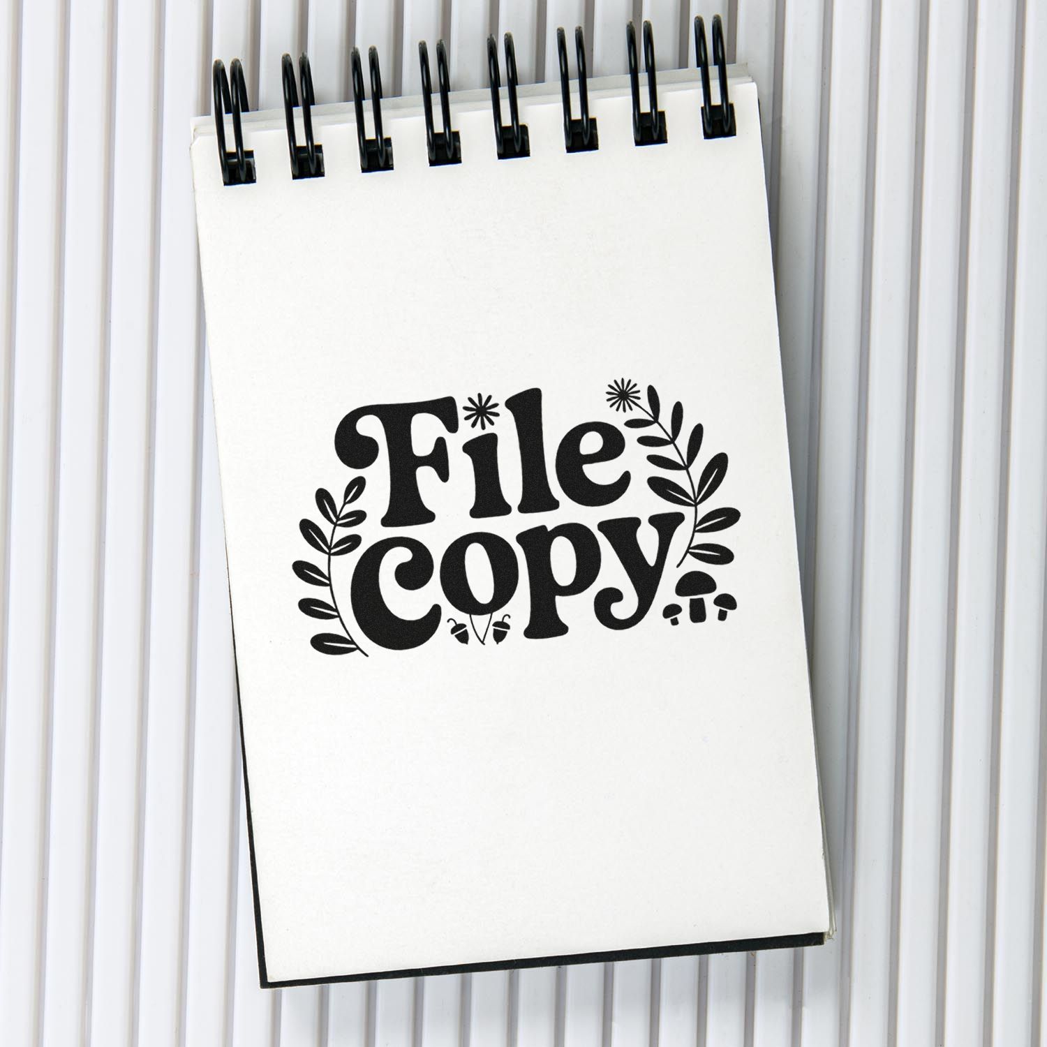 File Copy rubber stamp design on a spiral notebook, ideal for office document organization, filing, and record keeping.