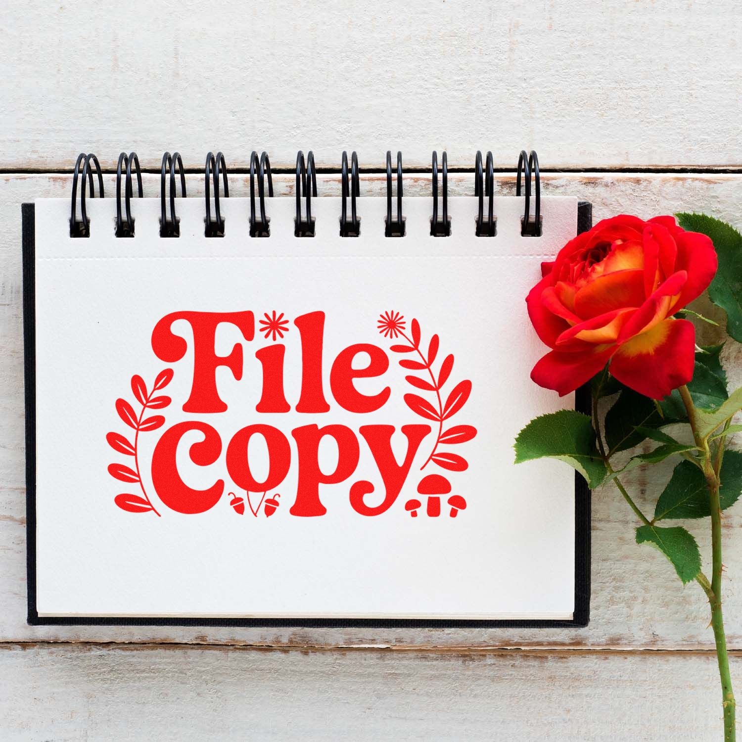 File Copy rubber stamp design on spiral notebook with rose, ideal for office filing, document marking, and organization.
