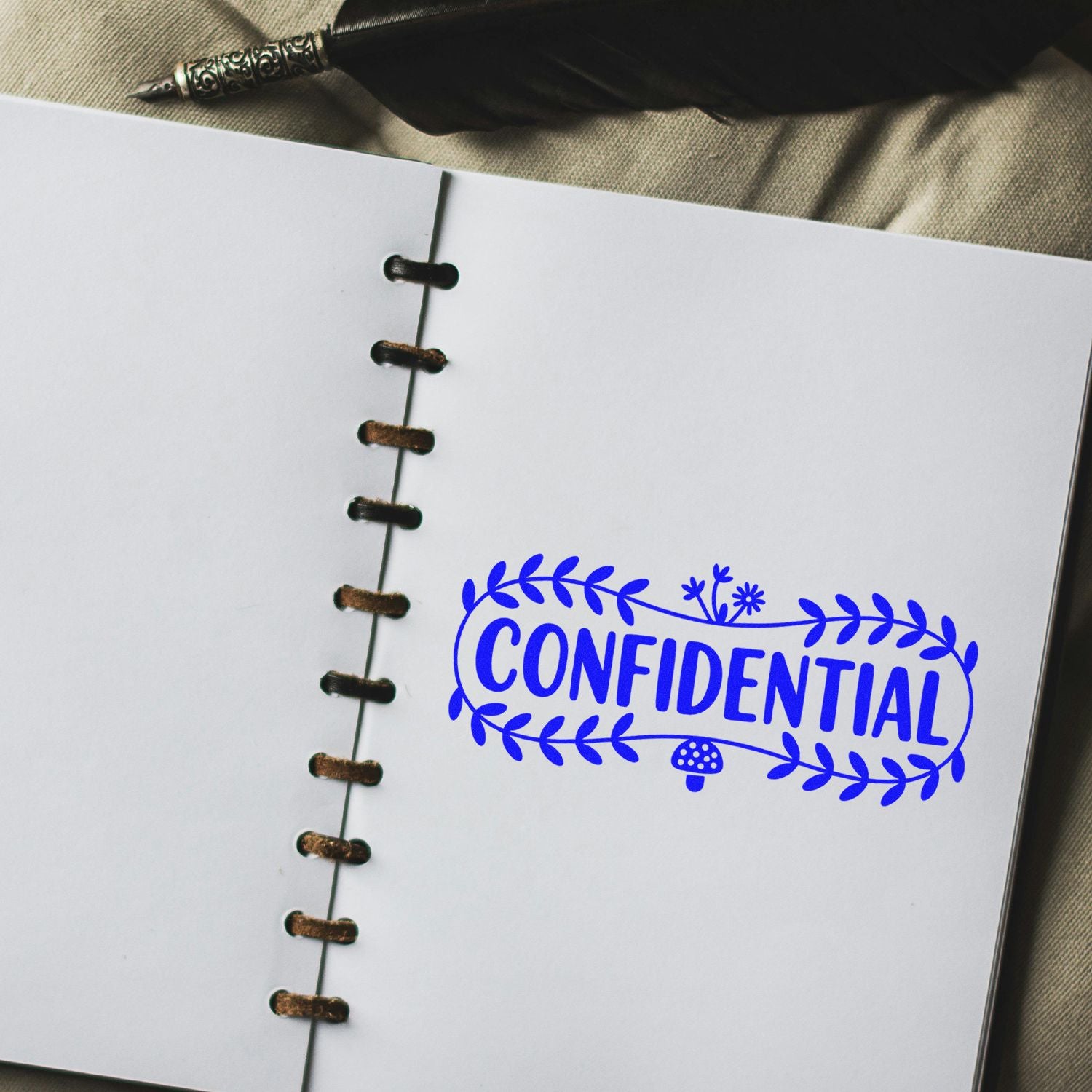 Custom confidential rubber stamp on a notebook page, ideal for marking sensitive documents and office files.