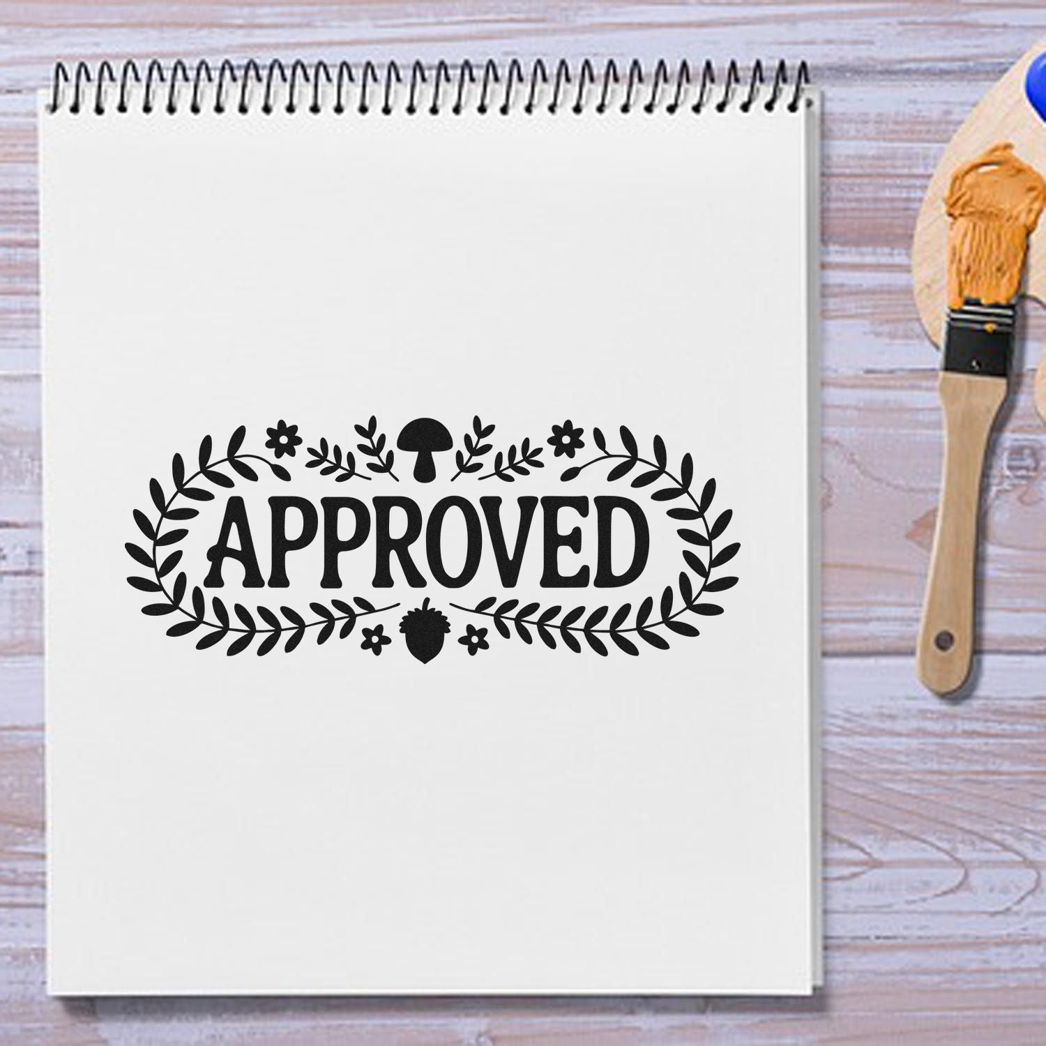Approved rubber stamp imprint on notebook page with floral border, ideal for office or classroom approval marking.