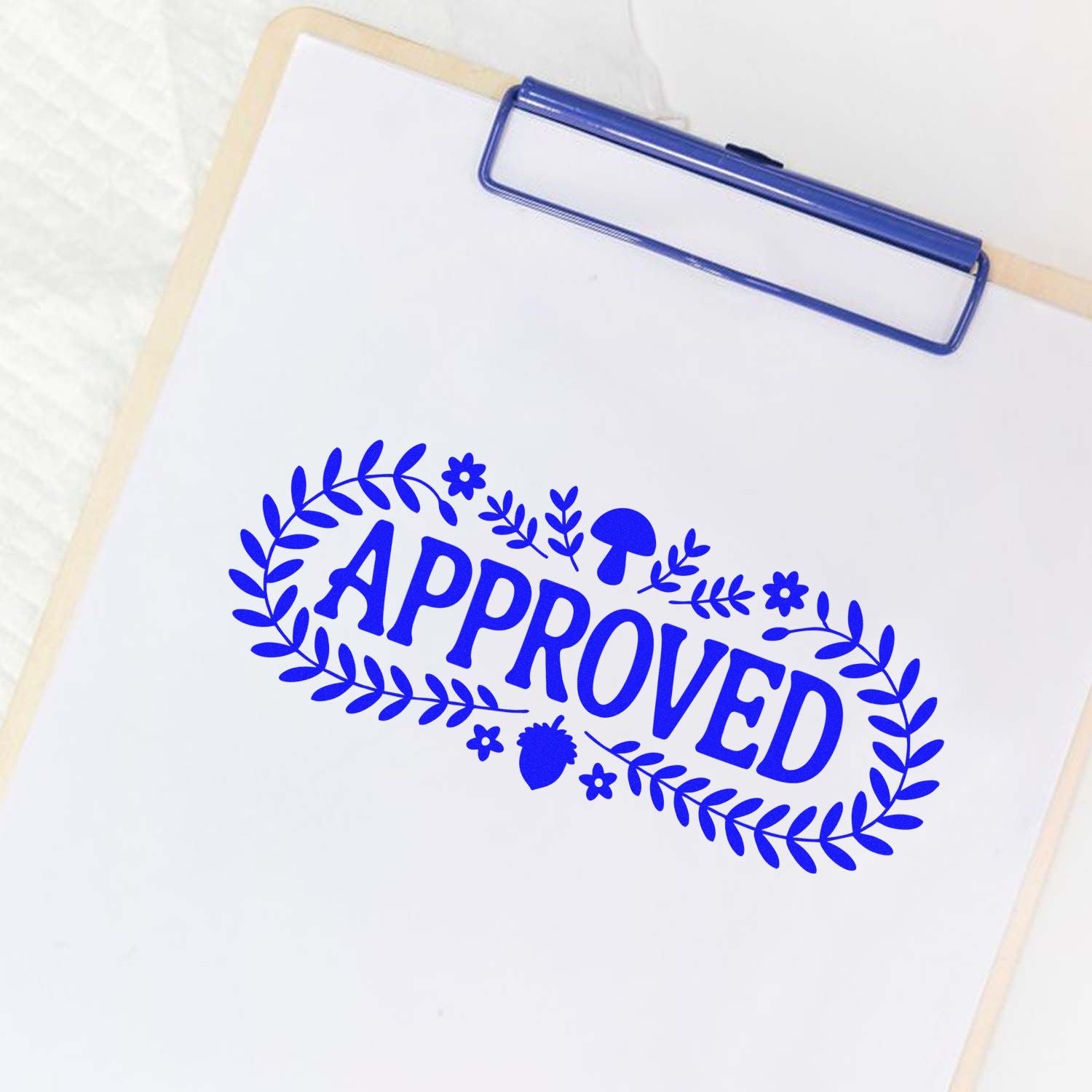 Blue APPROVED rubber stamp on clipboard, ideal for office document approval, business records, and custom stamping.