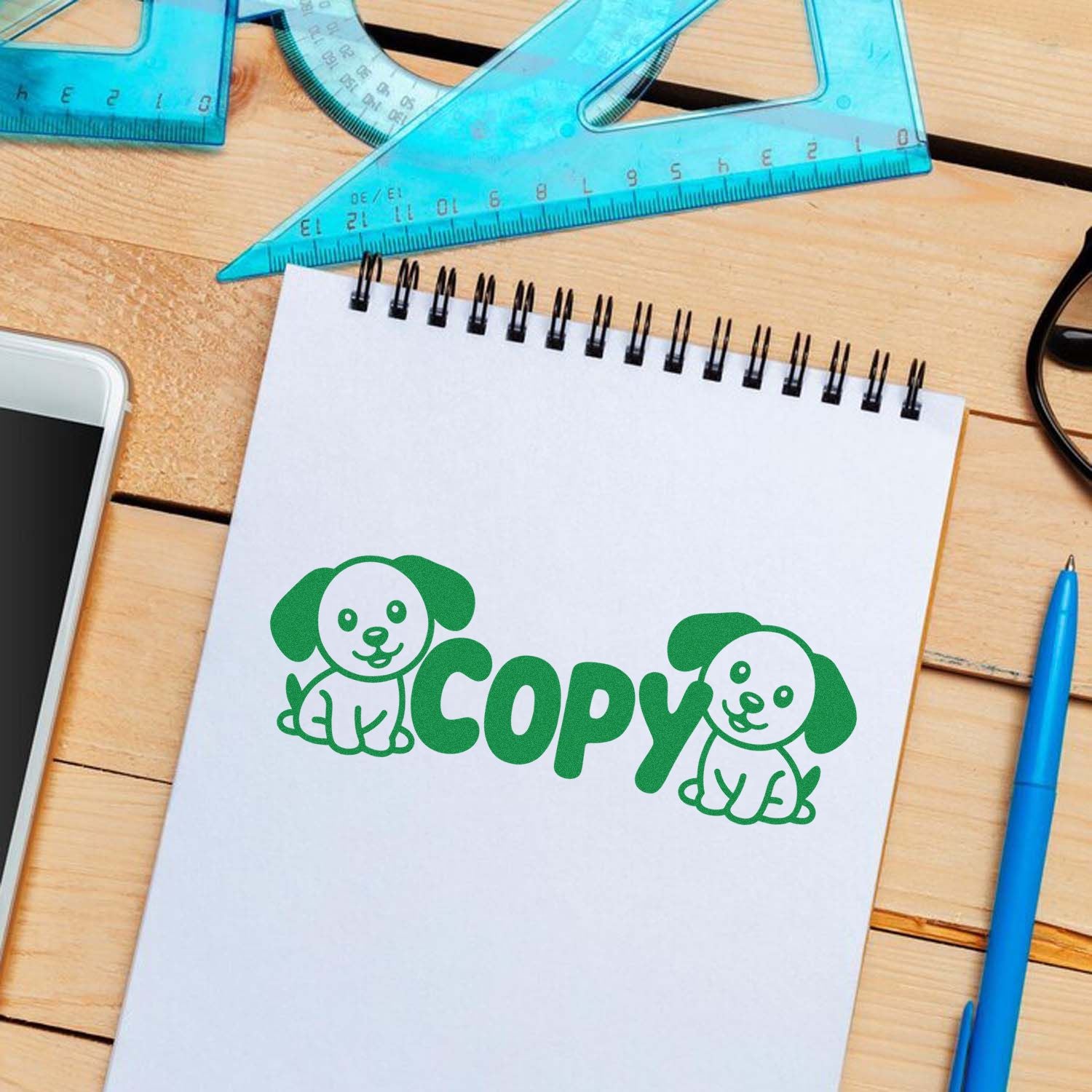 Green Copy rubber stamp with dog illustration on notebook, ideal for office documents, school papers, and labeling.