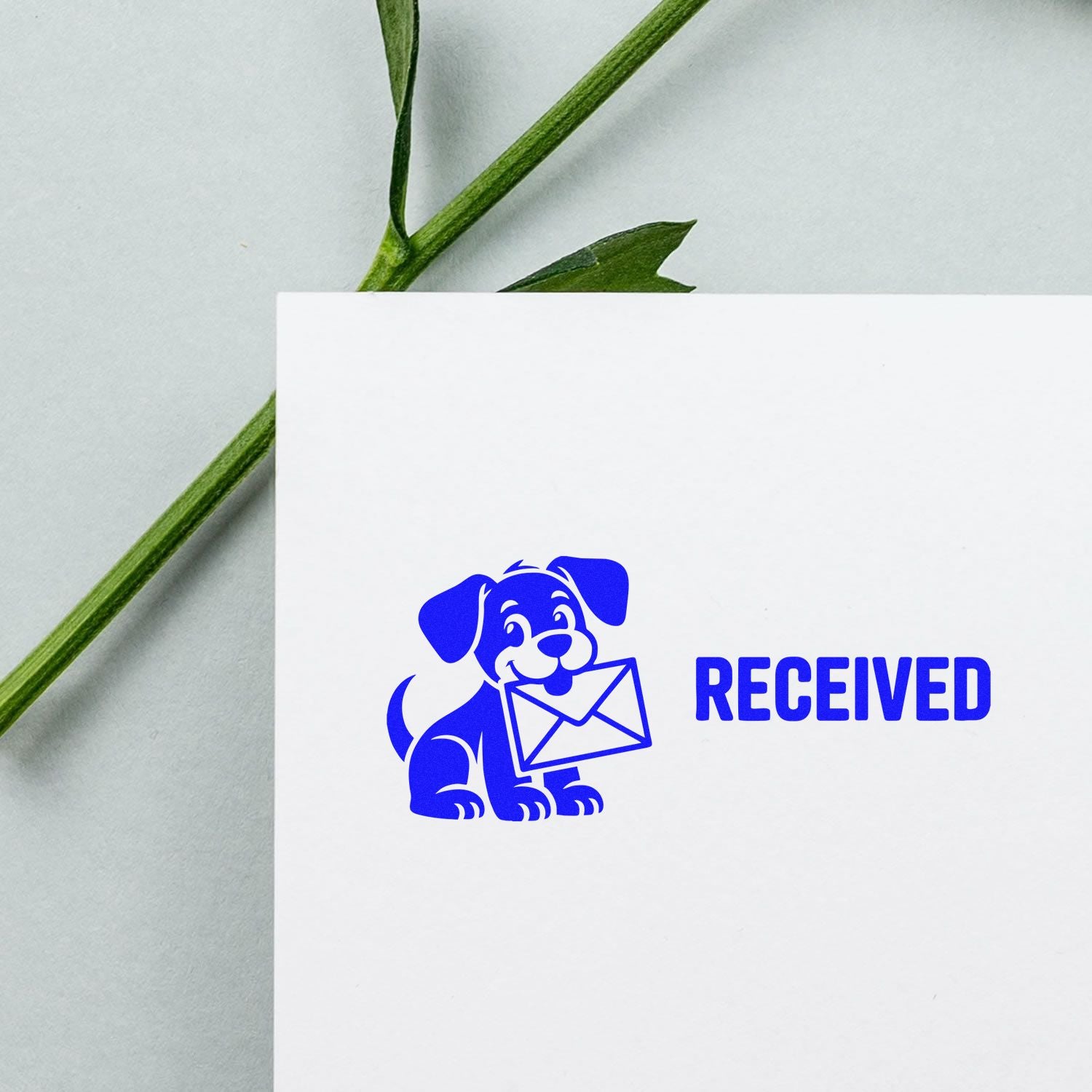 Blue received rubber stamp with dog and envelope icon on white paper, ideal for mail processing.