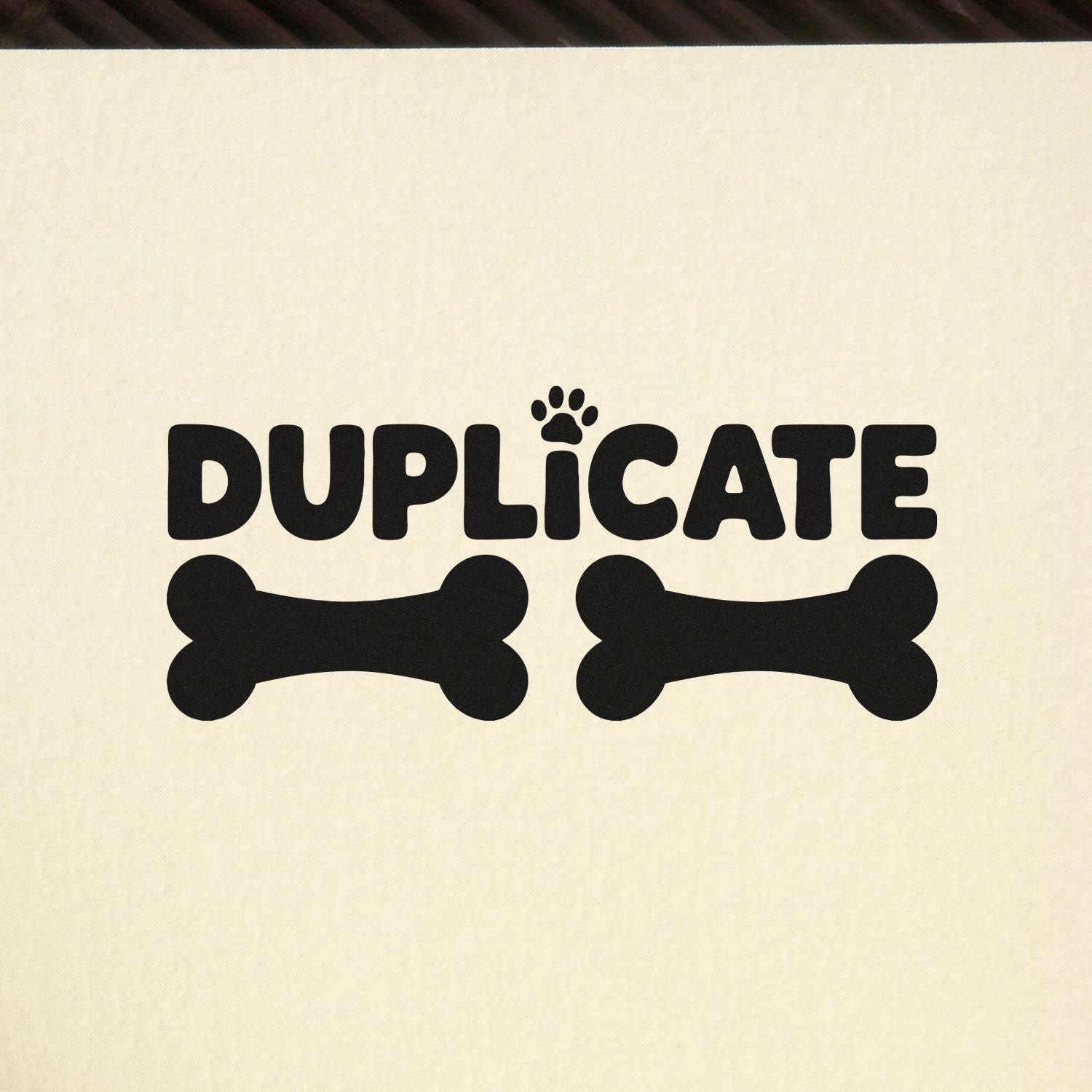 Pet-themed duplicate rubber stamp with paw print and bone icons for marking copies.