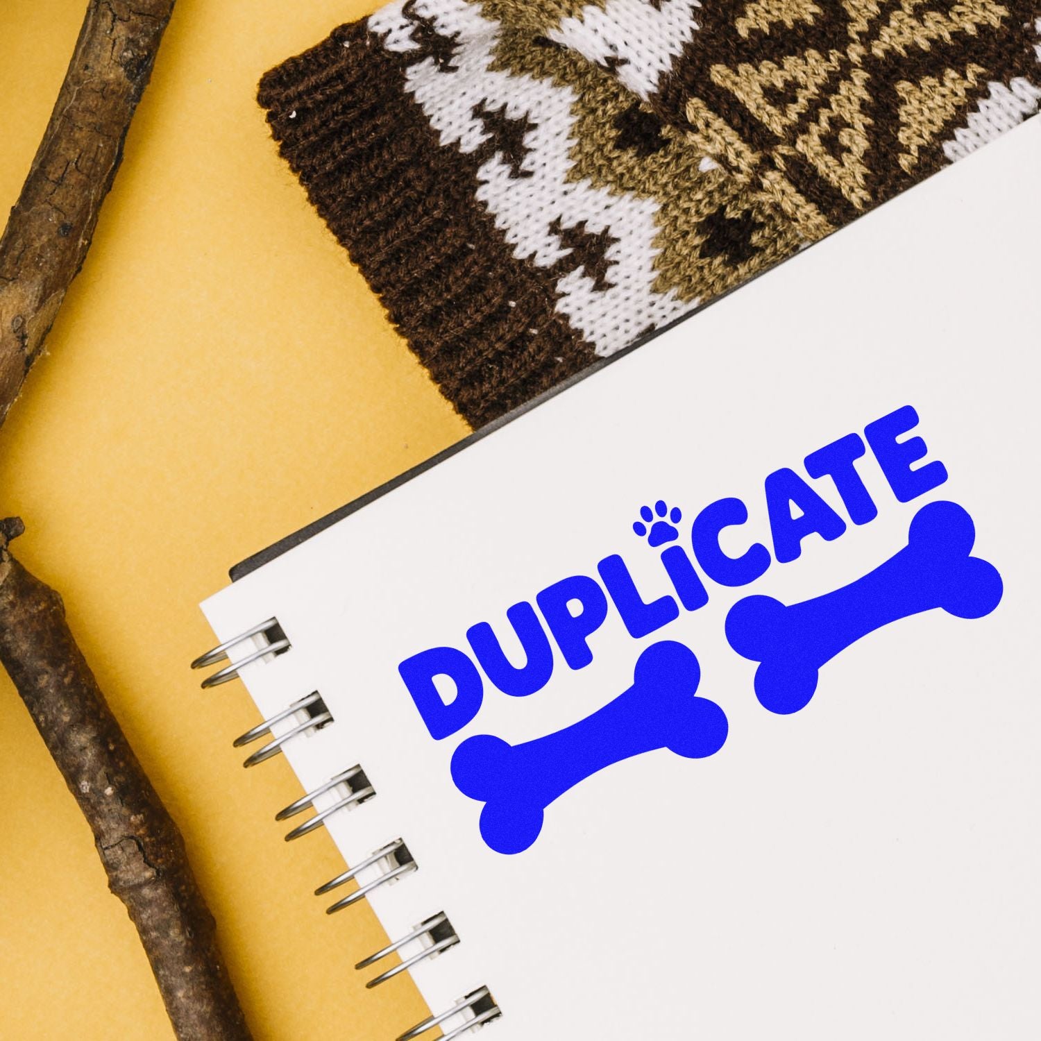 Blue duplicate rubber stamp imprint with bone icons on notebook, ideal for pet business document labeling.
