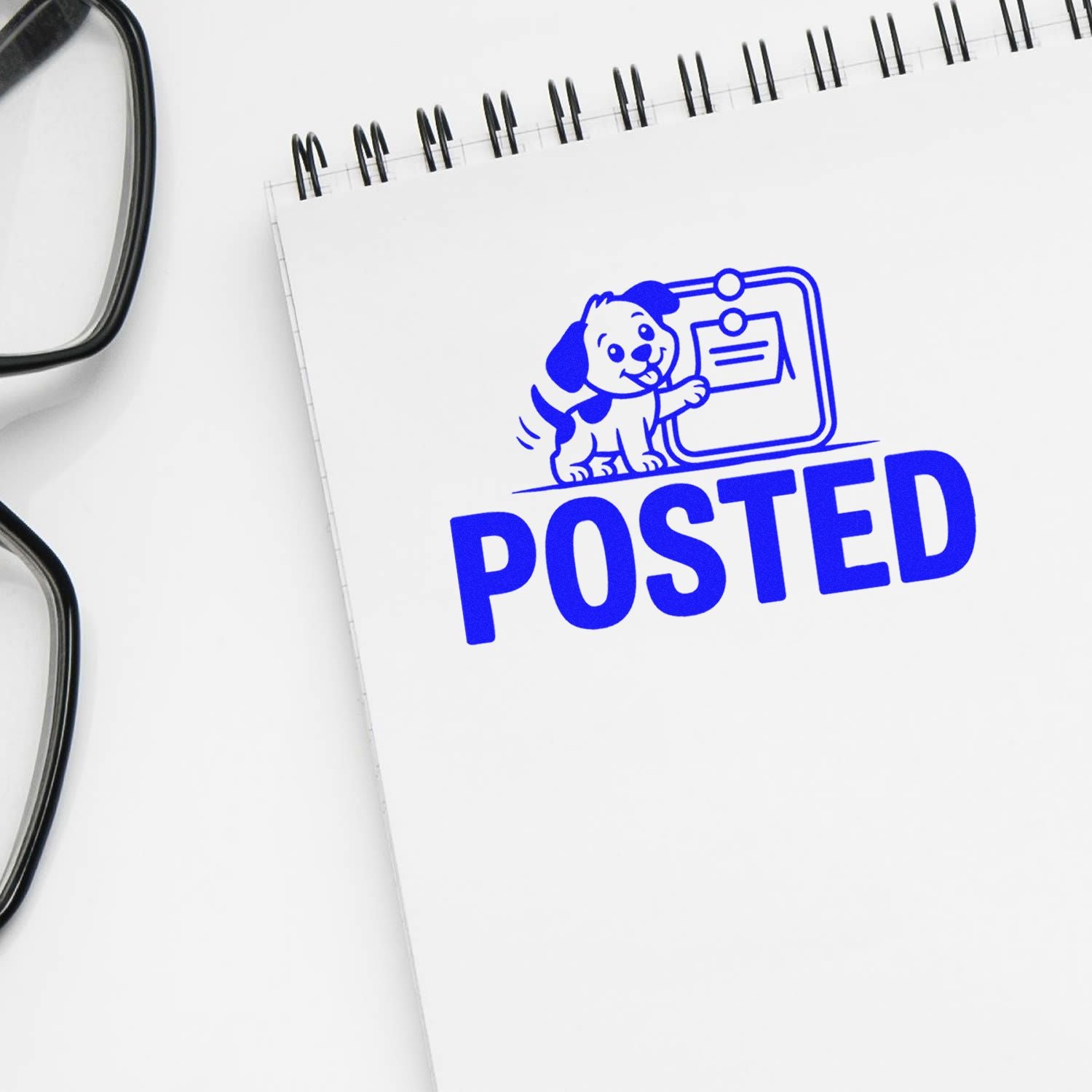 Blue POSTED rubber stamp with dog icon on notebook for office mail, document approval, and record processing.