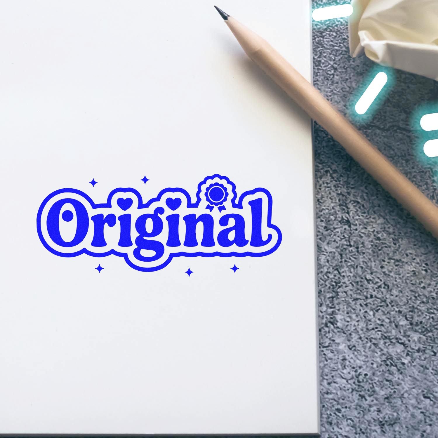 Blue Original rubber stamp design on notebook page, perfect for branding handmade products, crafts, and custom stationery.