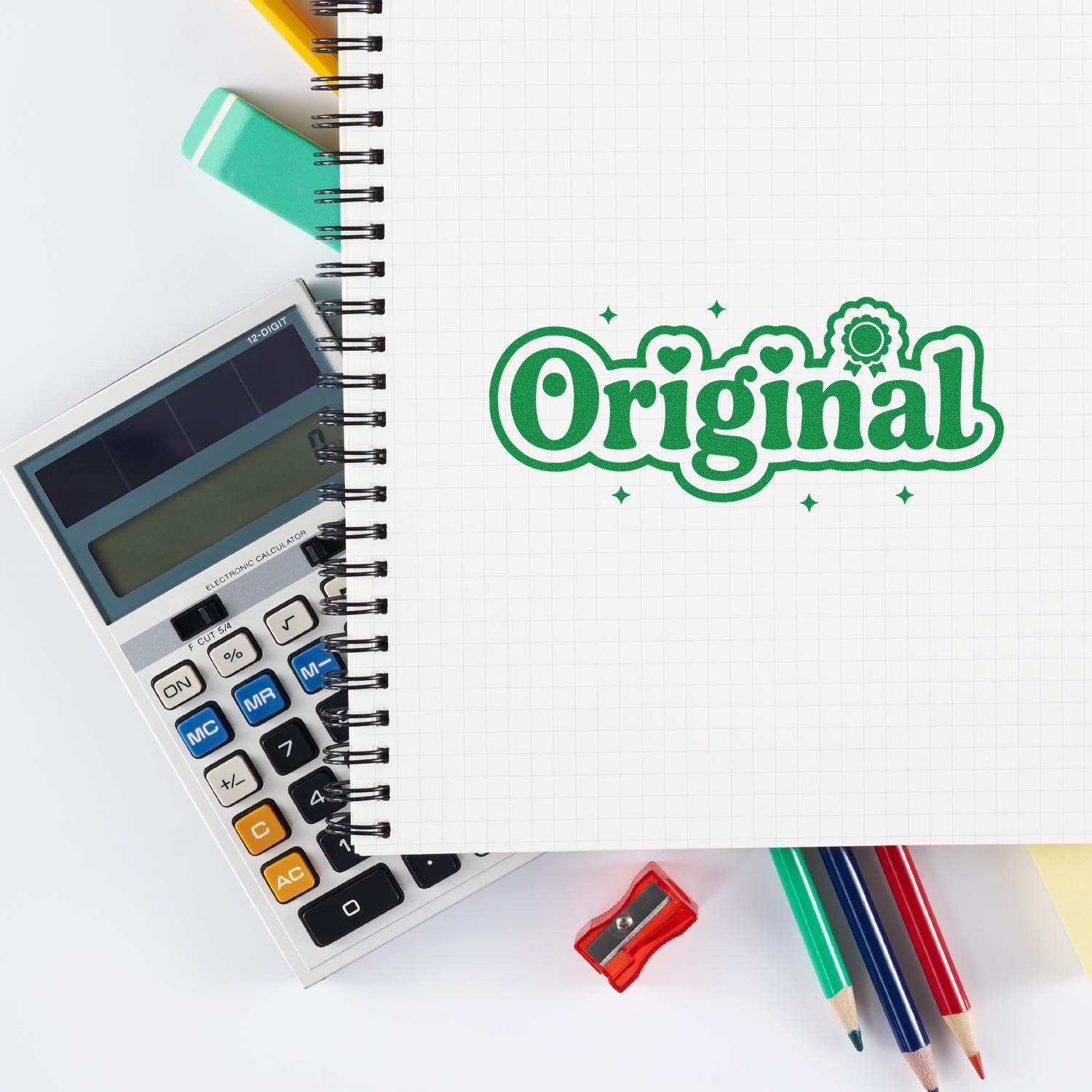 Original rubber stamp imprint on notebook with calculator and pencils for office, school, or creative branding.