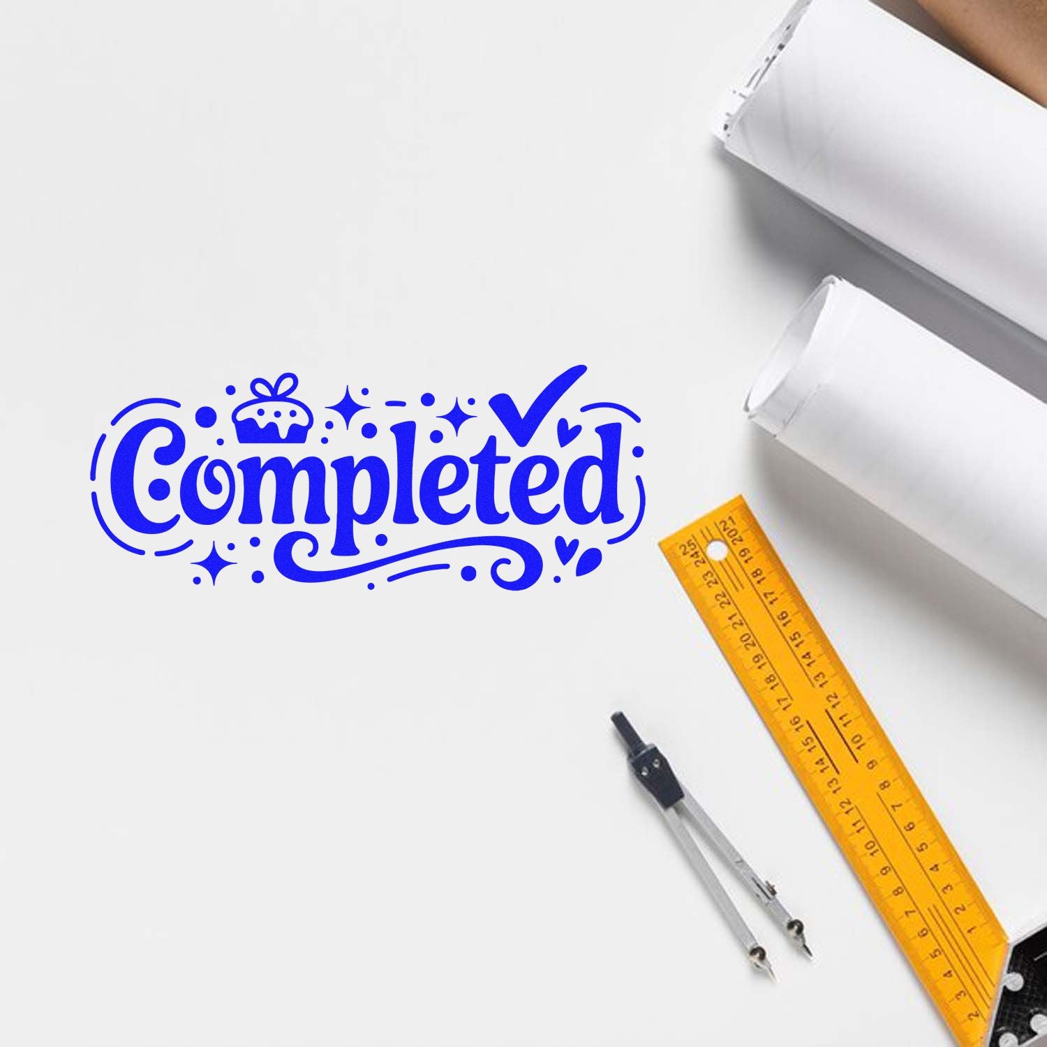 Blue Completed rubber stamp design on white paper with ruler and drafting tools, ideal for marking finished projects.