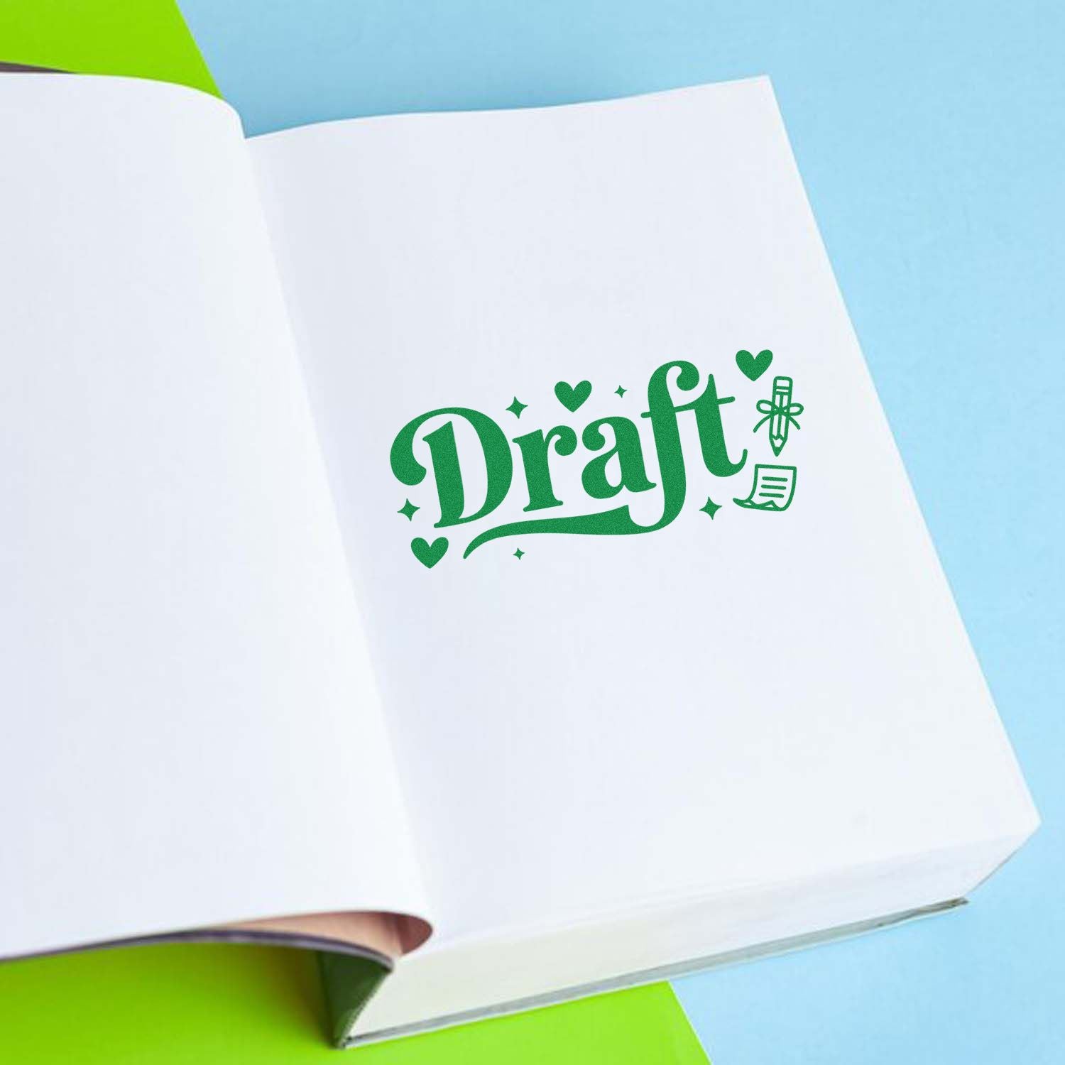 Green draft rubber stamp on an open notebook, ideal for proofreading, document review, and office approval marking.