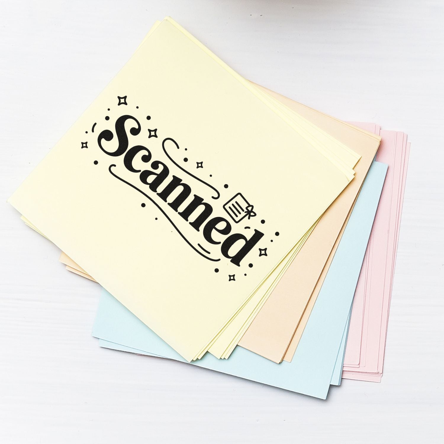 Scanned rubber stamp on pastel paper sheets for marking office documents and file organization.