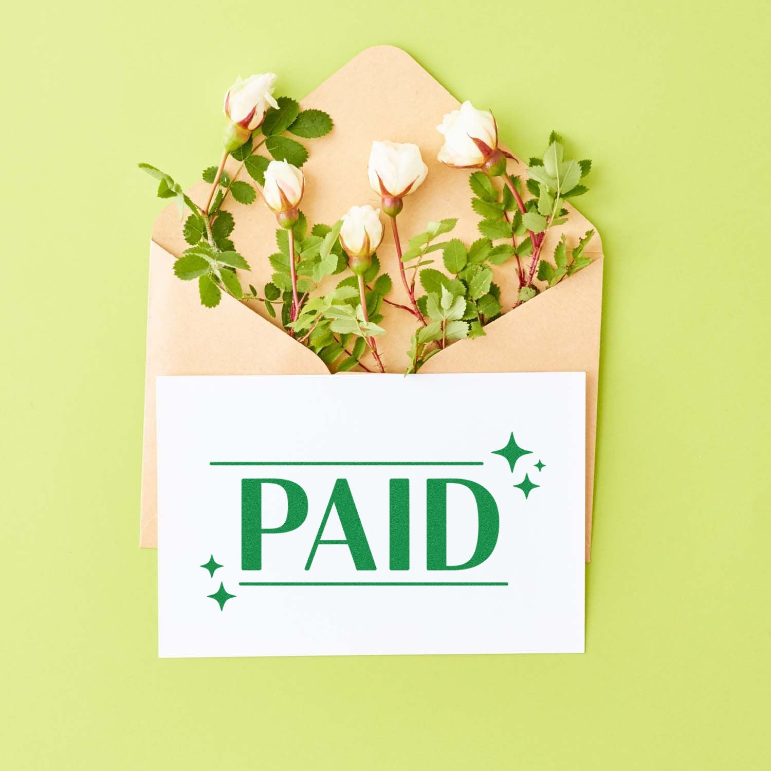 PAID rubber stamp on a card with envelope, for marking invoices and business documents as paid.