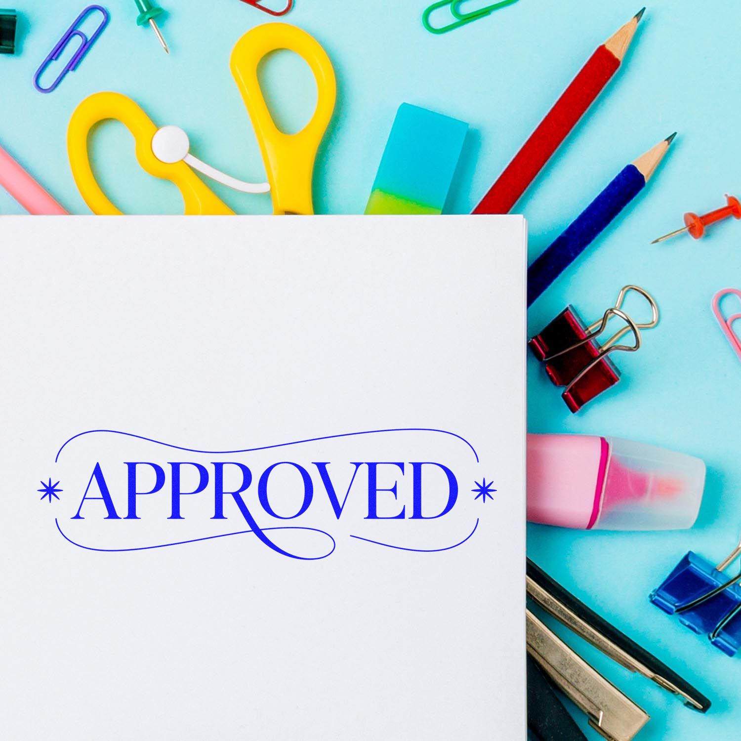 Approved rubber stamp on white paper with colorful office supplies, pencils, and clips on a blue background.