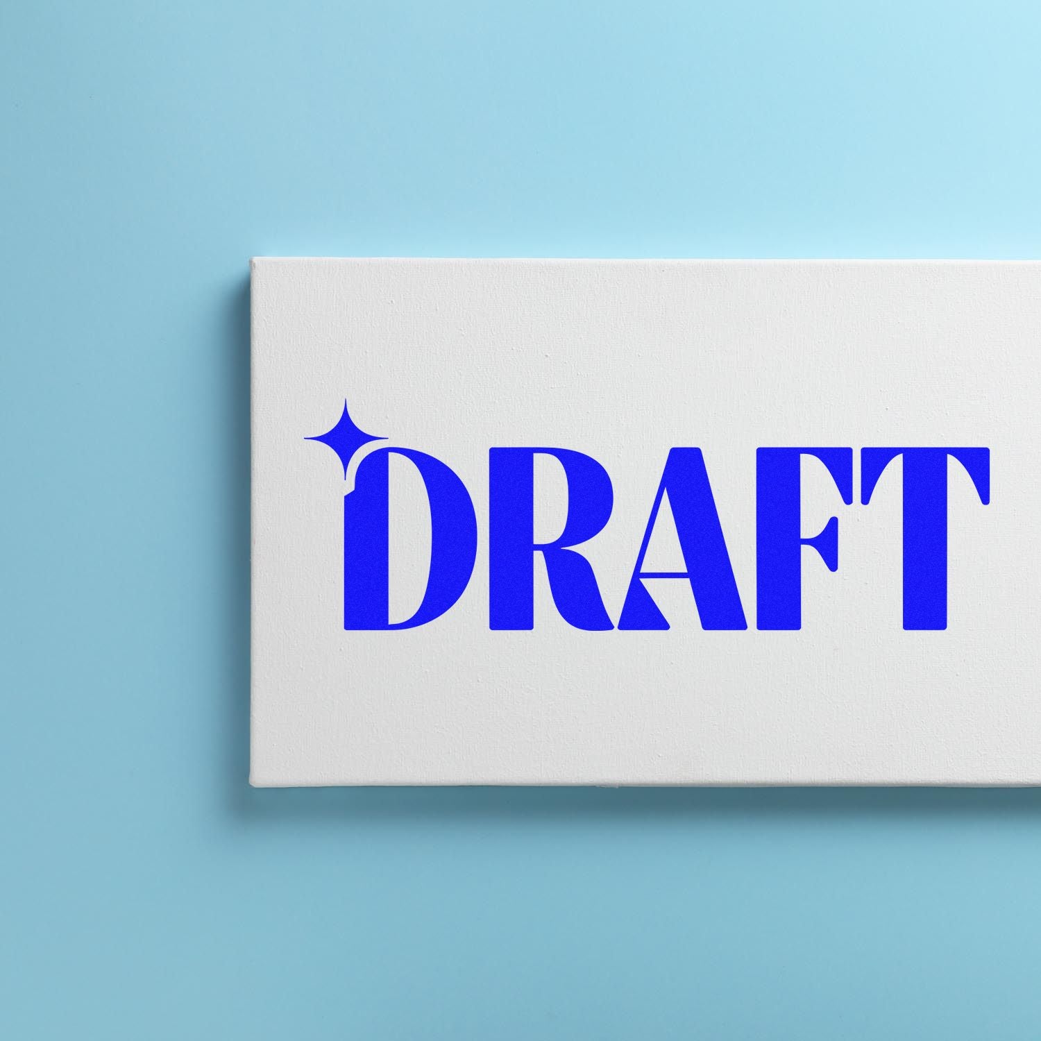 Blue DRAFT rubber stamp on a white block, perfect for labeling draft documents and office paperwork.