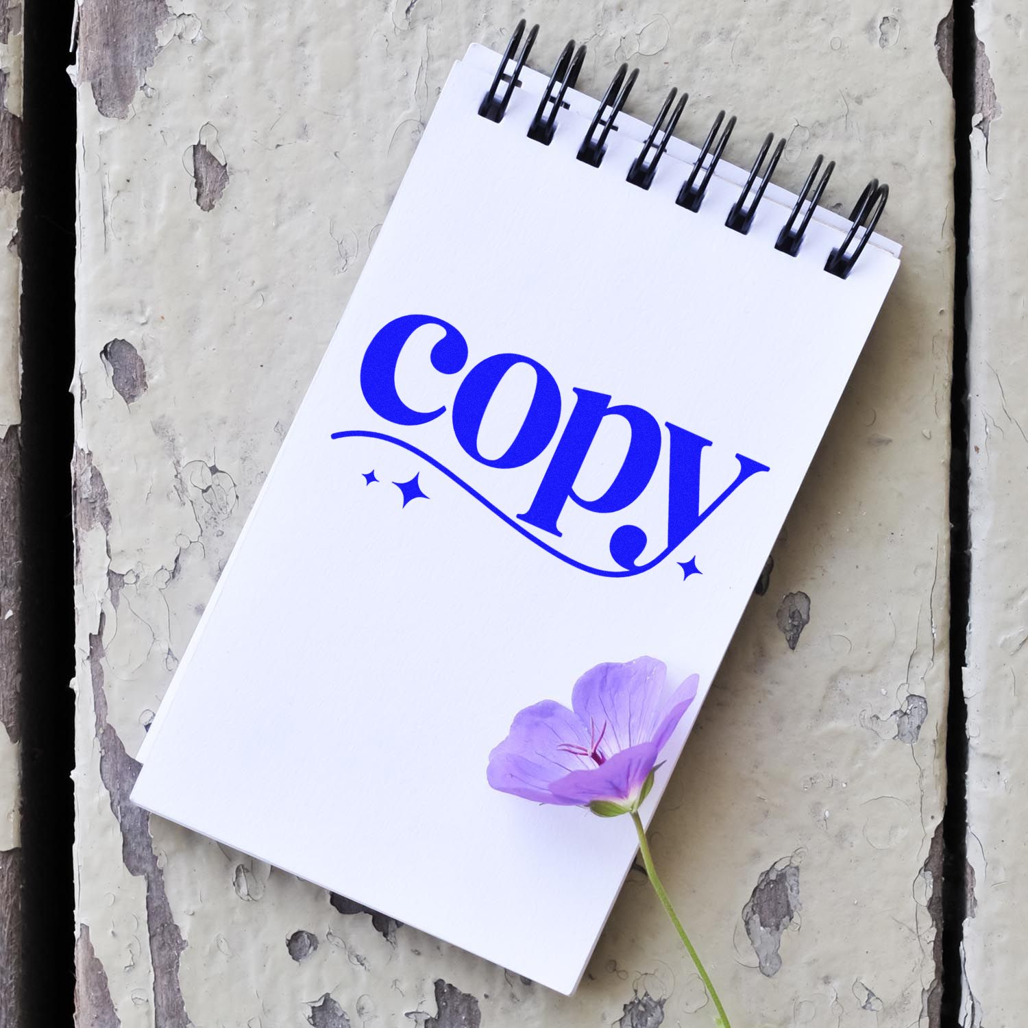 Blue Copy rubber stamp impression on spiral notebook, ideal for office document labeling and custom stamp branding.